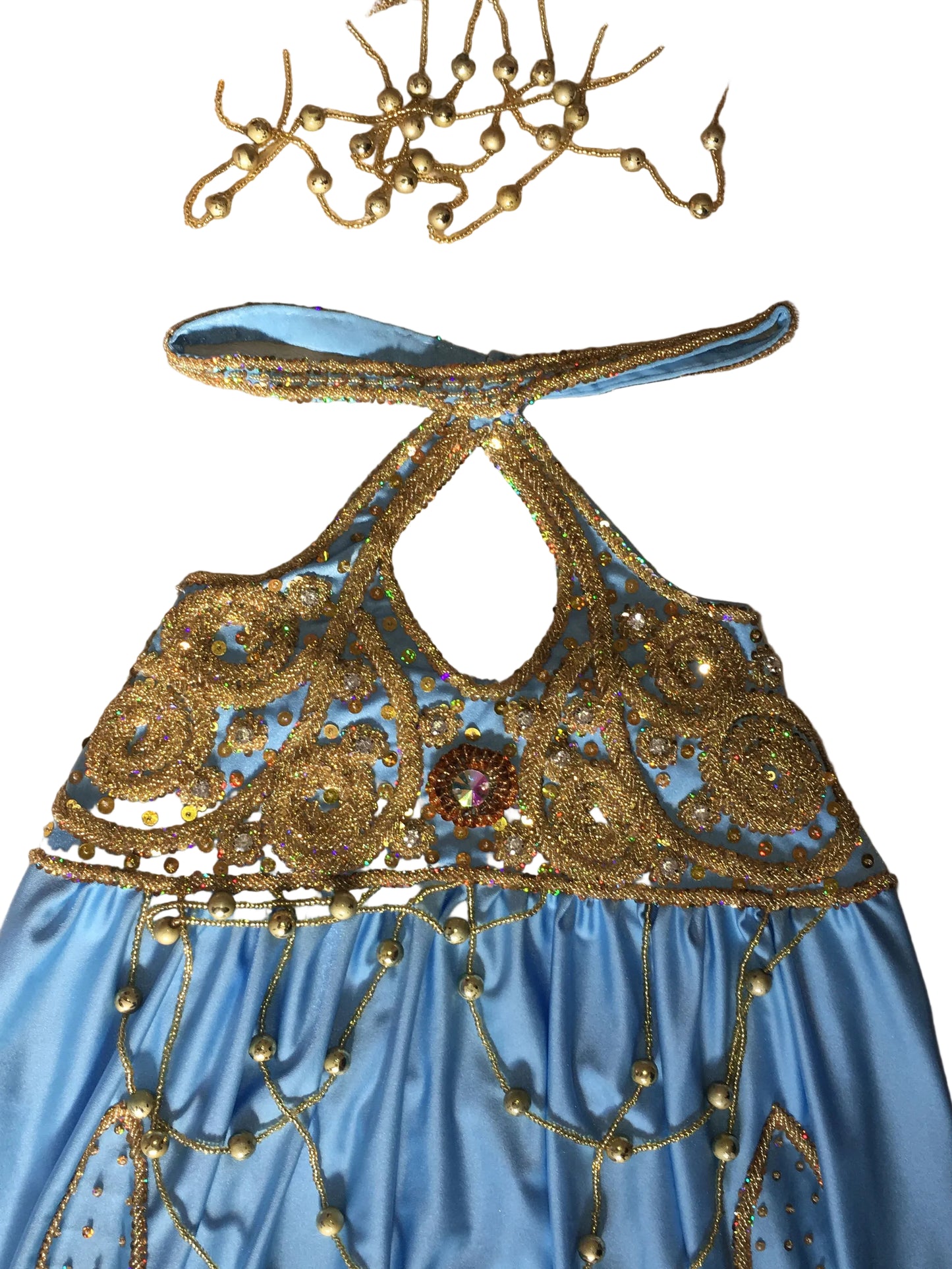 Blue dress with gold embroidery on a beige background
