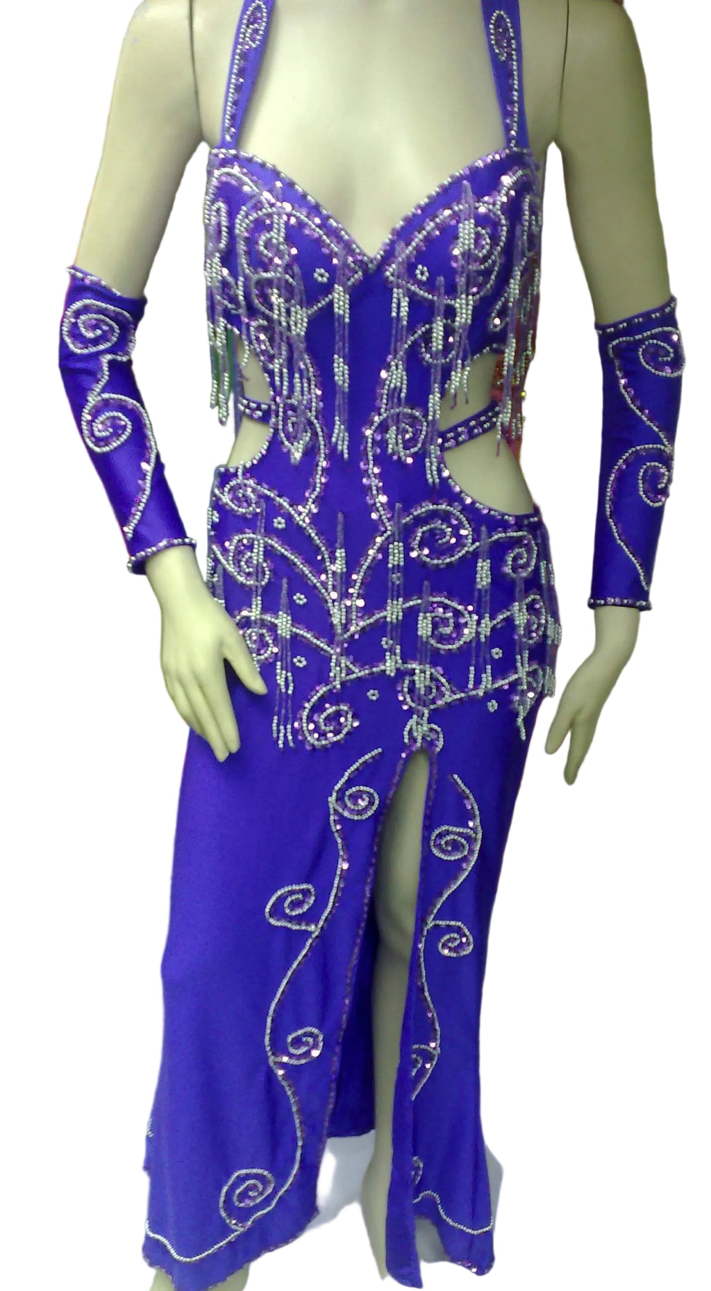 A mannequin displaying a professional belly dance costume with a purple color, featuring glass beads and sequins decorations, a front slit skirt, and a headband.