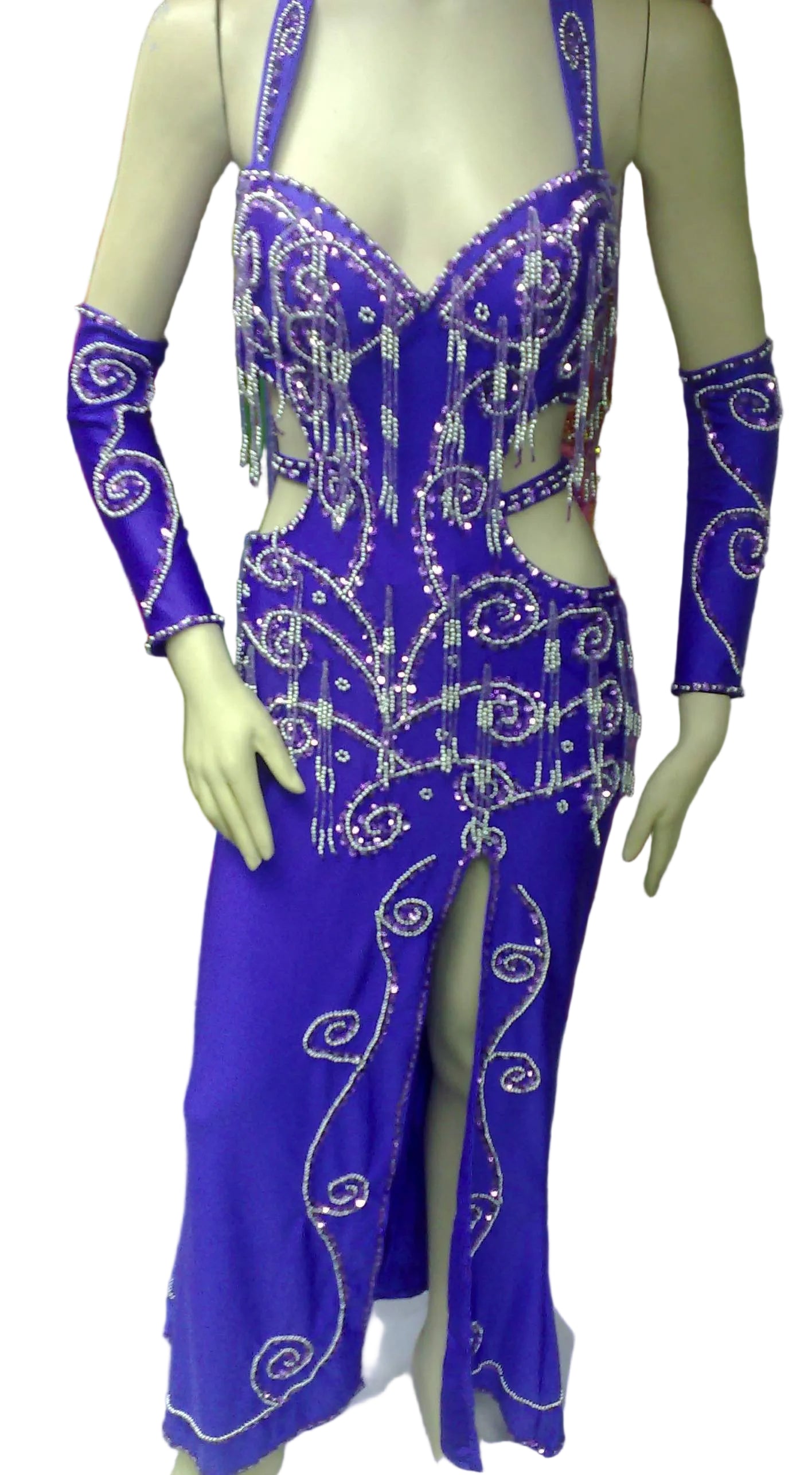 A mannequin displaying a professional belly dance costume with a purple color, featuring glass beads and sequins decorations, a front slit skirt, and a headband.