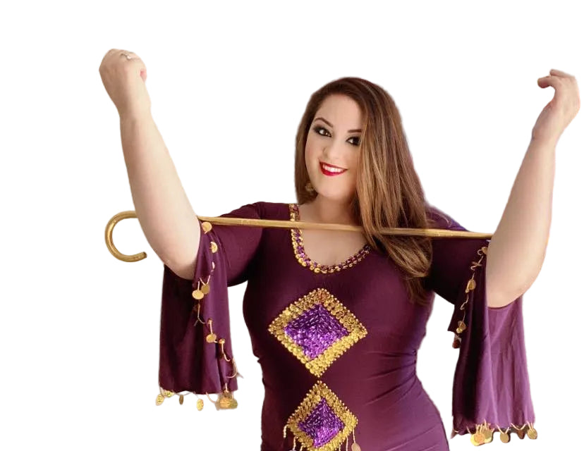 Woman wearing a purple dress with gold accents, holding a cane on a white background