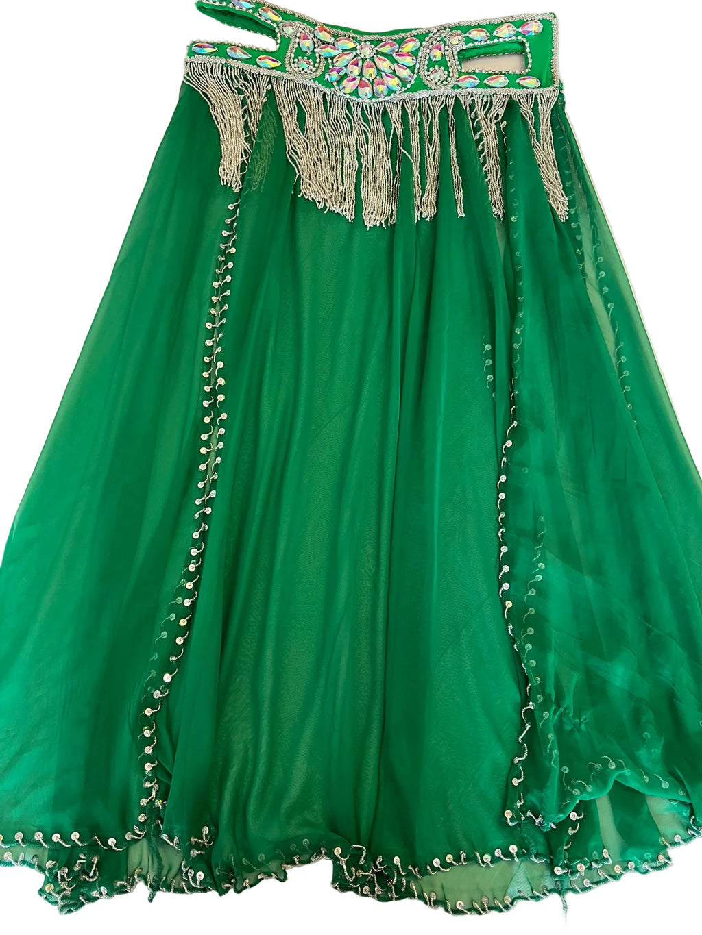 Green dress with decorative elements on a white surface
