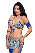 Woman wearing a blue and silver costume with intricate designs on a white background