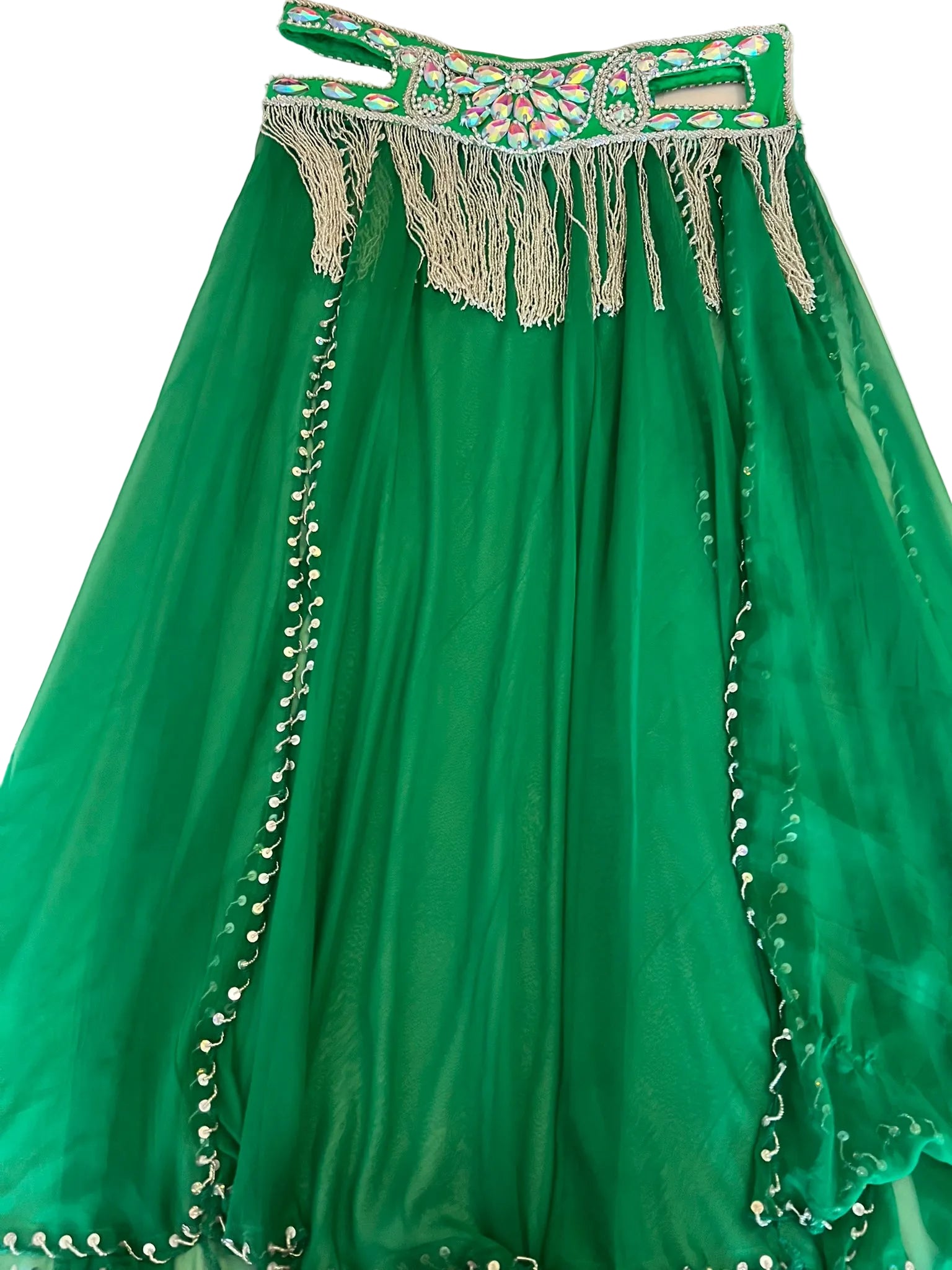 Green traditional dress with decorative top on a white surface