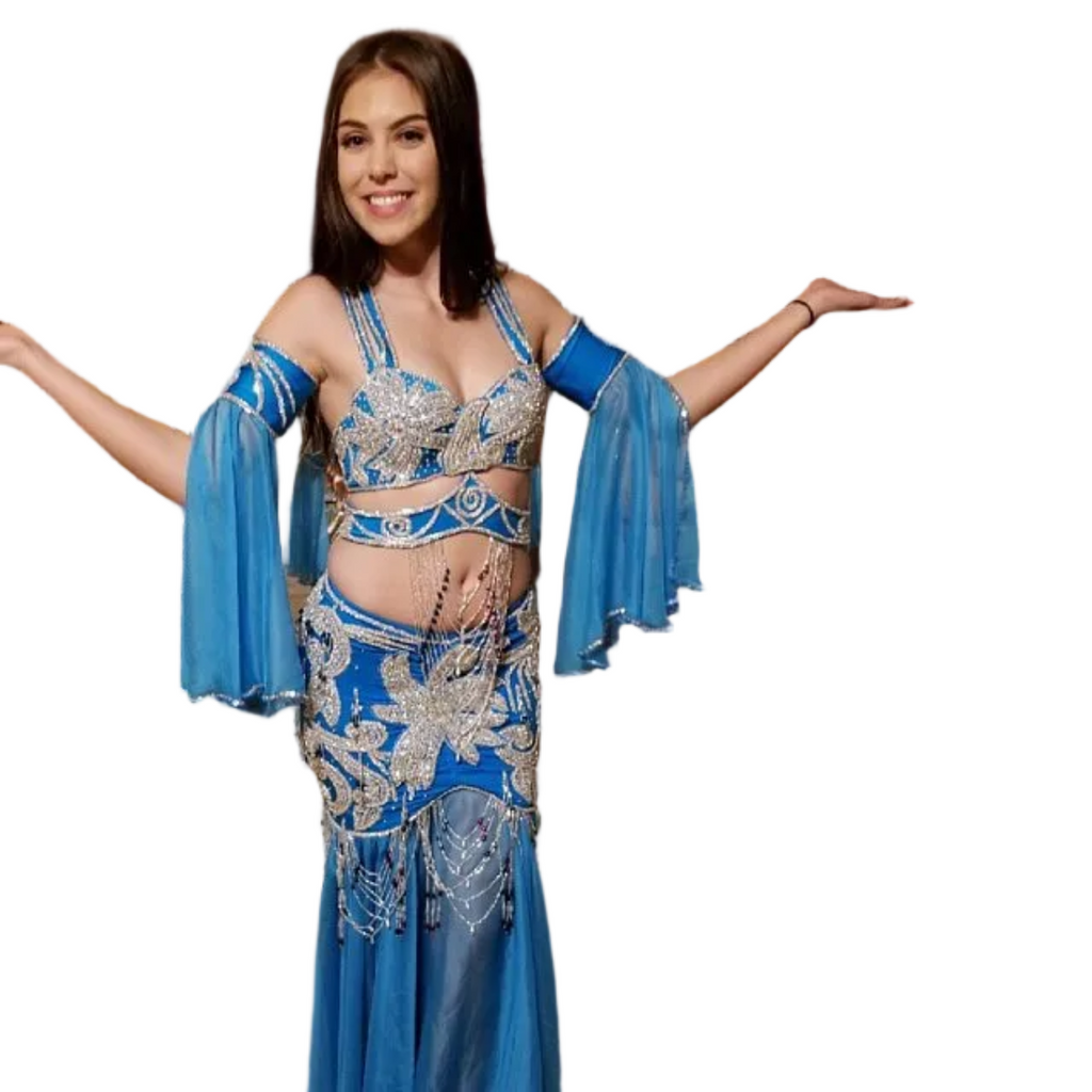 Woman wearing a blue and silver belly dance costume on a white background