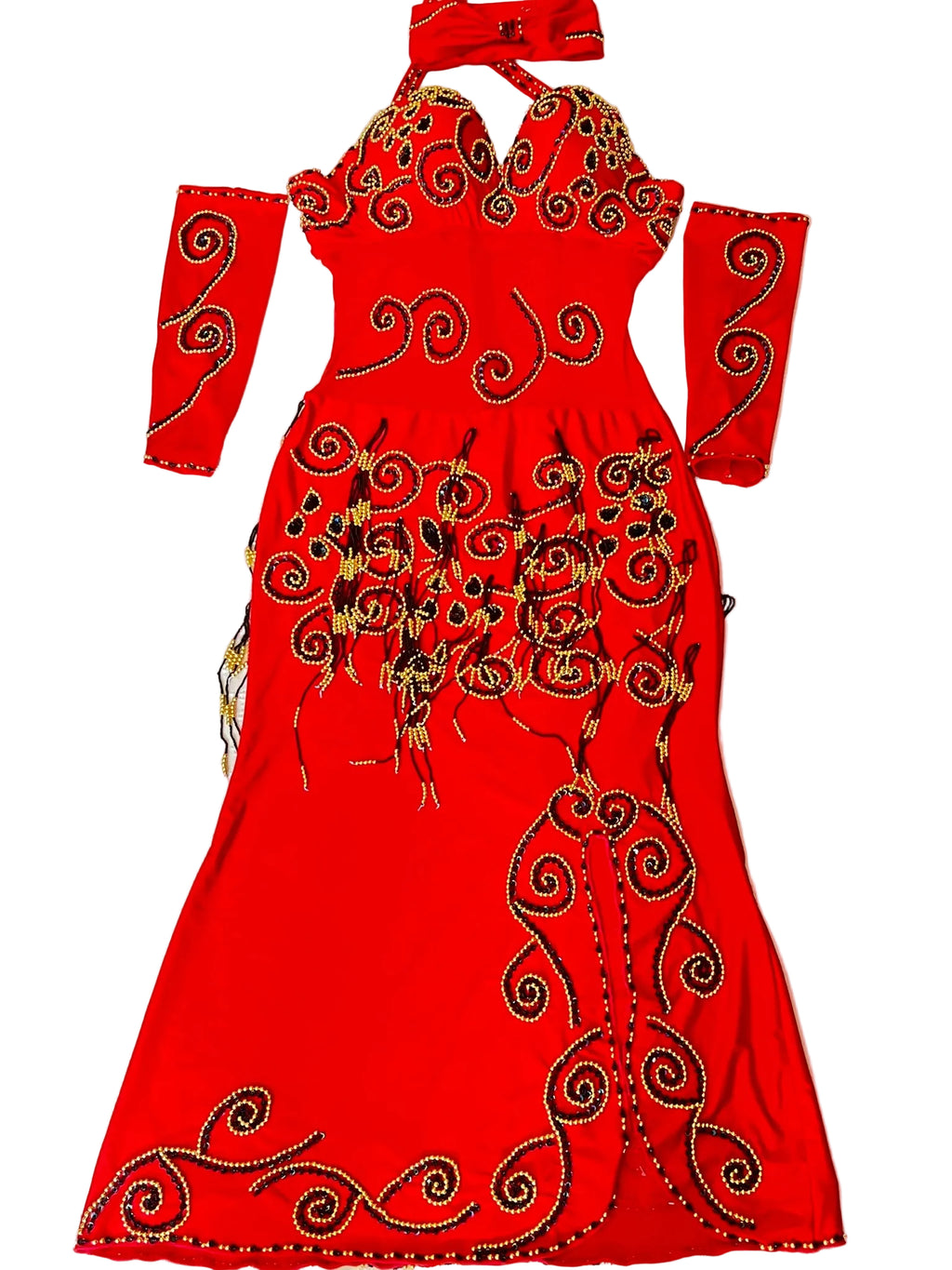 A vibrant red professional belly dance dress with ornate gold embellishments, arm pieces, and a headpiece laid out on a flat surface.
