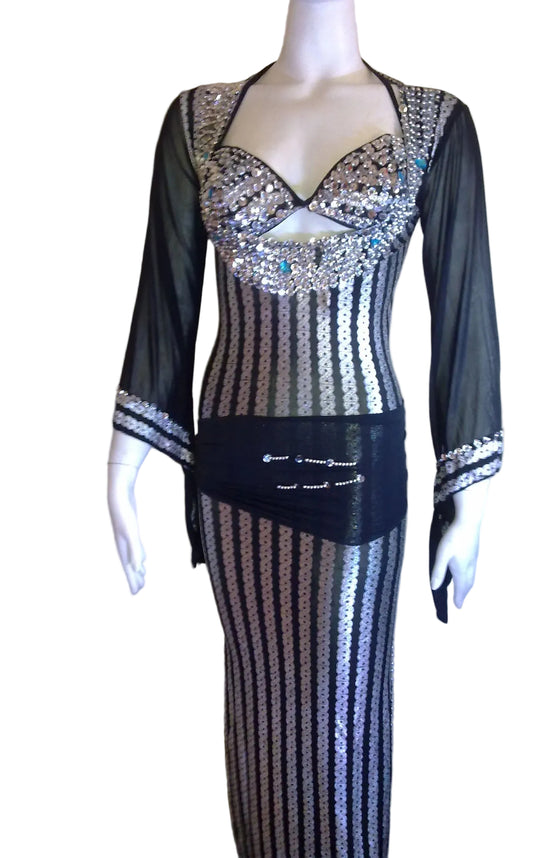 Mannequin wearing a black and silver dress with intricate detailing, branded 'Luxor Bazar'.