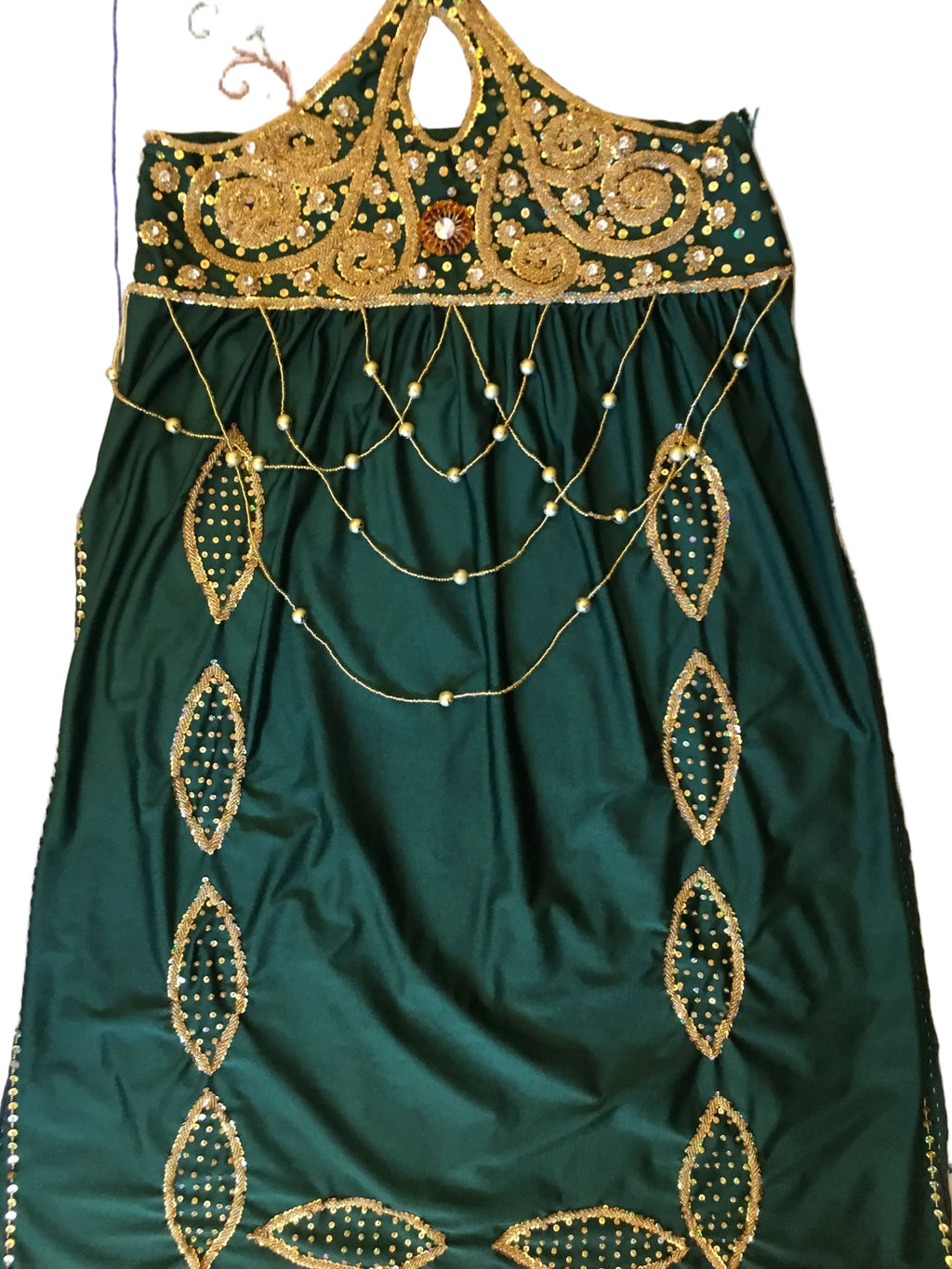 Green fabric with gold embroidery on a floral background