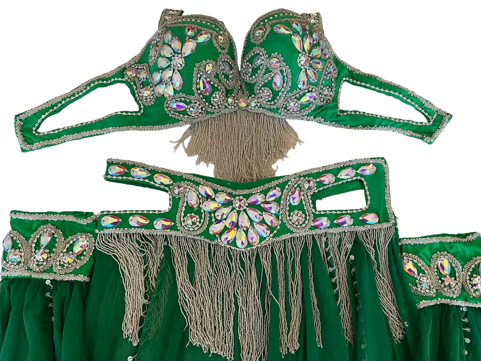 Green costume with embellishments and fringes on a white surface