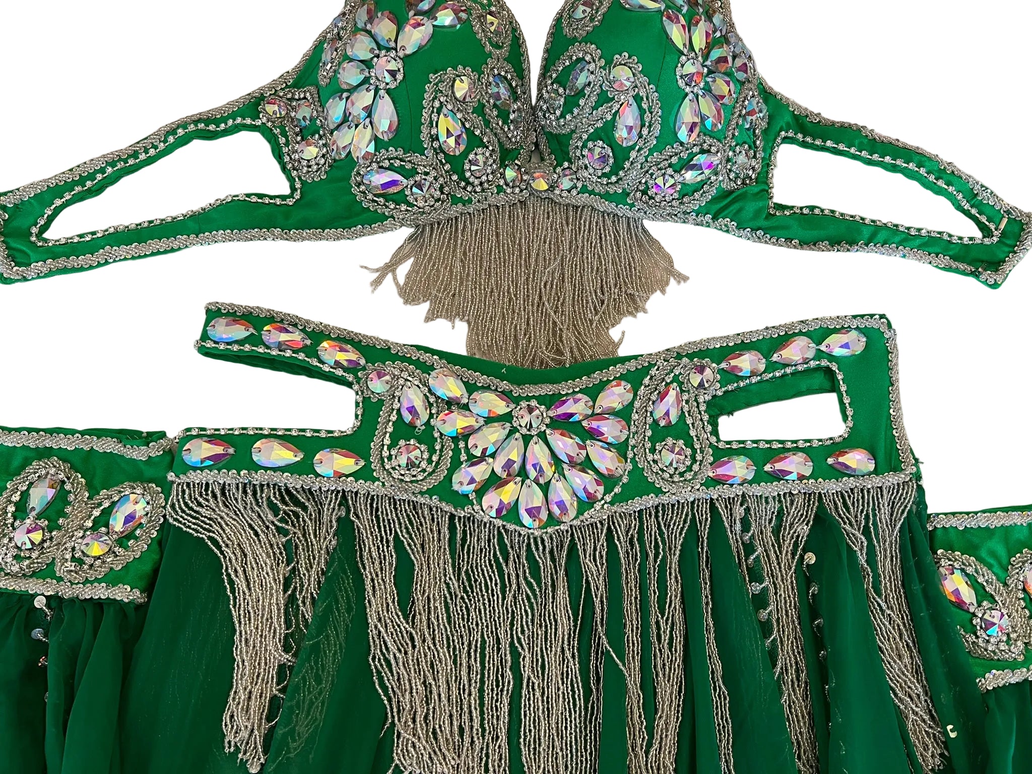 Green costume with intricate beadwork and tassels on a white surface