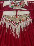A red belly dance costume set featuring a heavily embellished bra top and matching hip scarf, both decorated with gold beads, white pearl-like fringe, and colorful rhinestones, laid flat on a light surface.