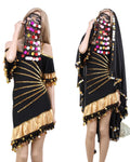 Two models wearing black belly dance dresses with gold embellishments and sequins. One model is covering her face and the other is not.