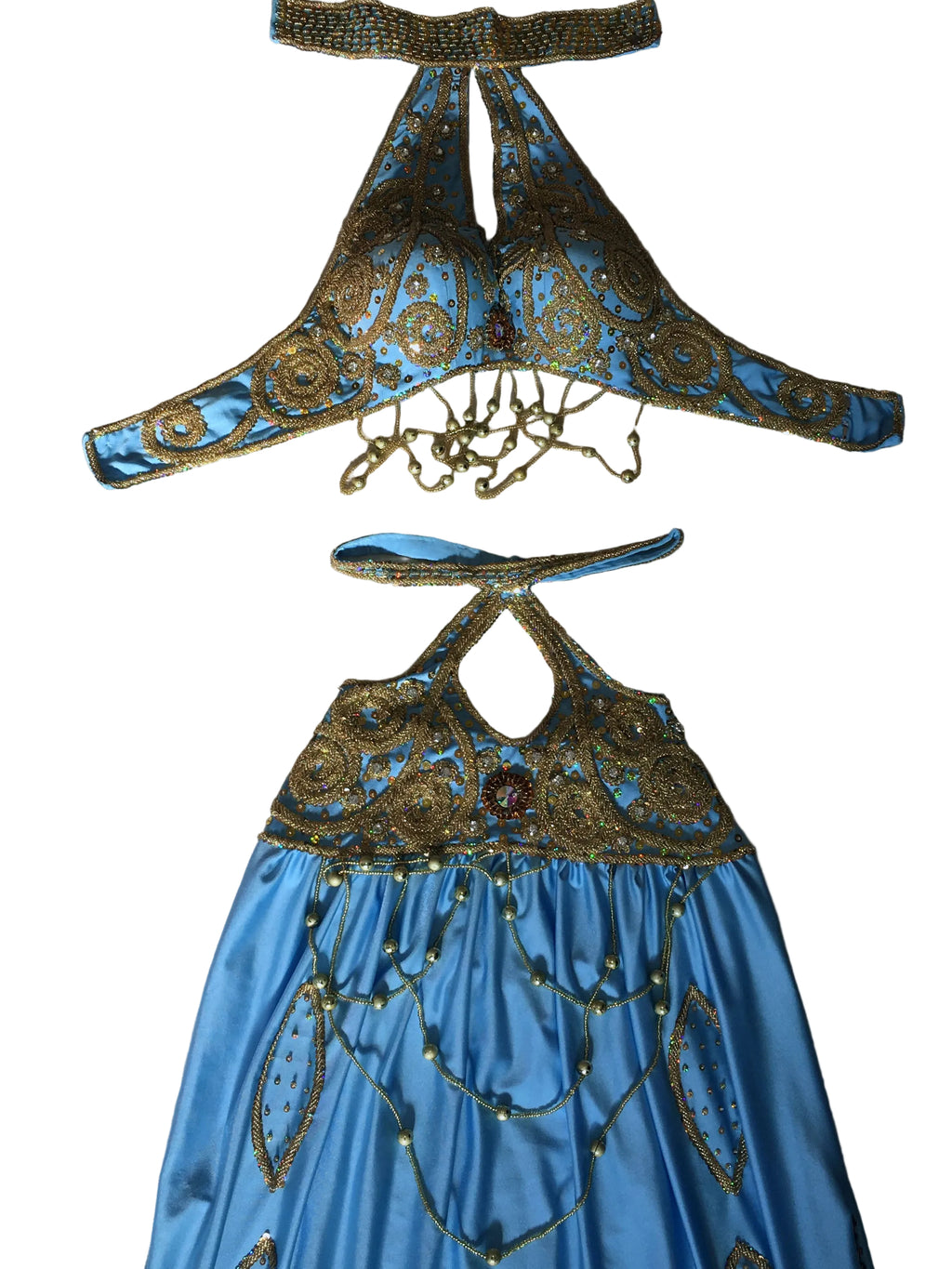 Blue dress with gold embellishments on a beige surface