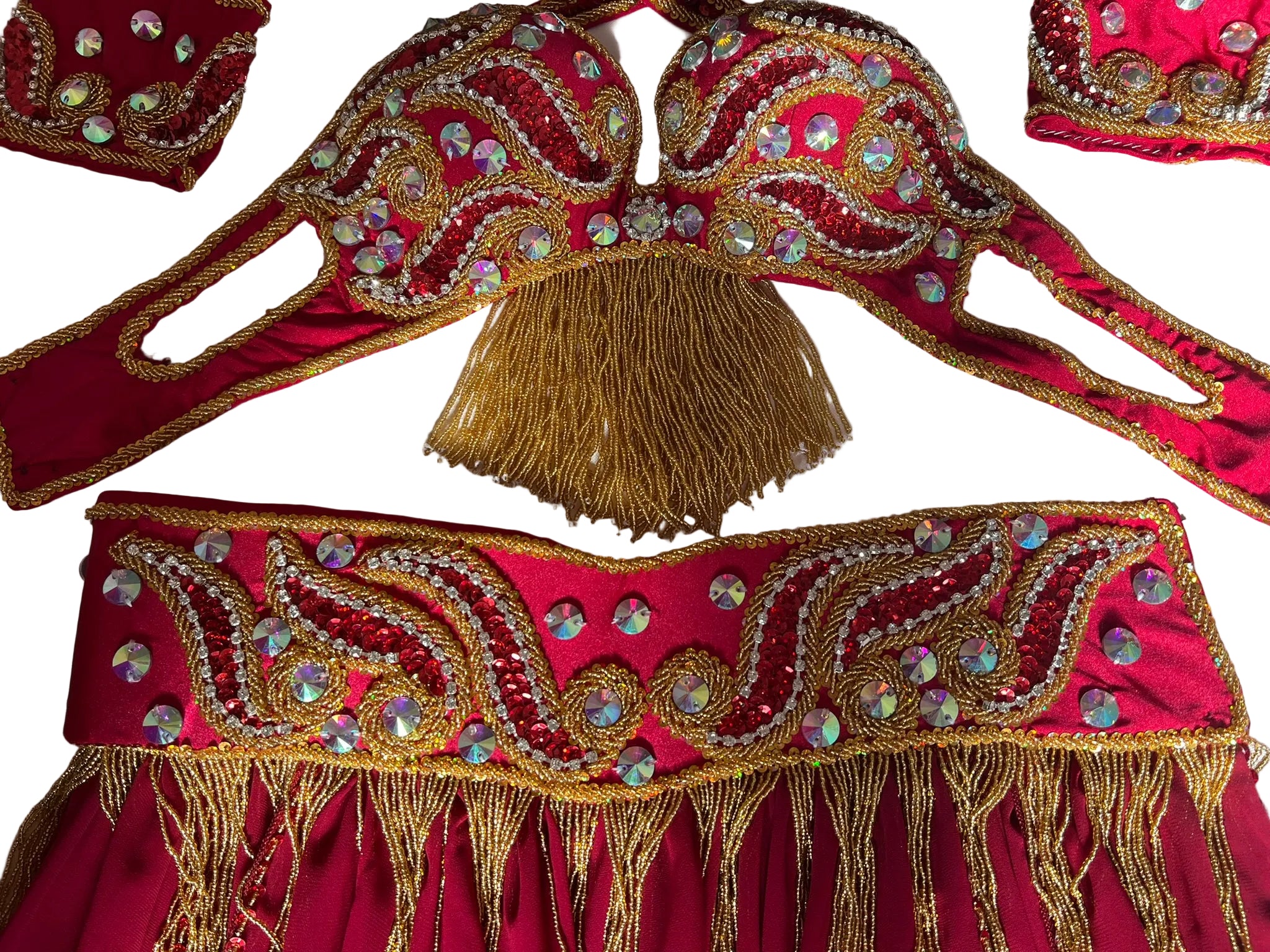 Decorative red and gold costume piece with intricate patterns and tassels on a white background