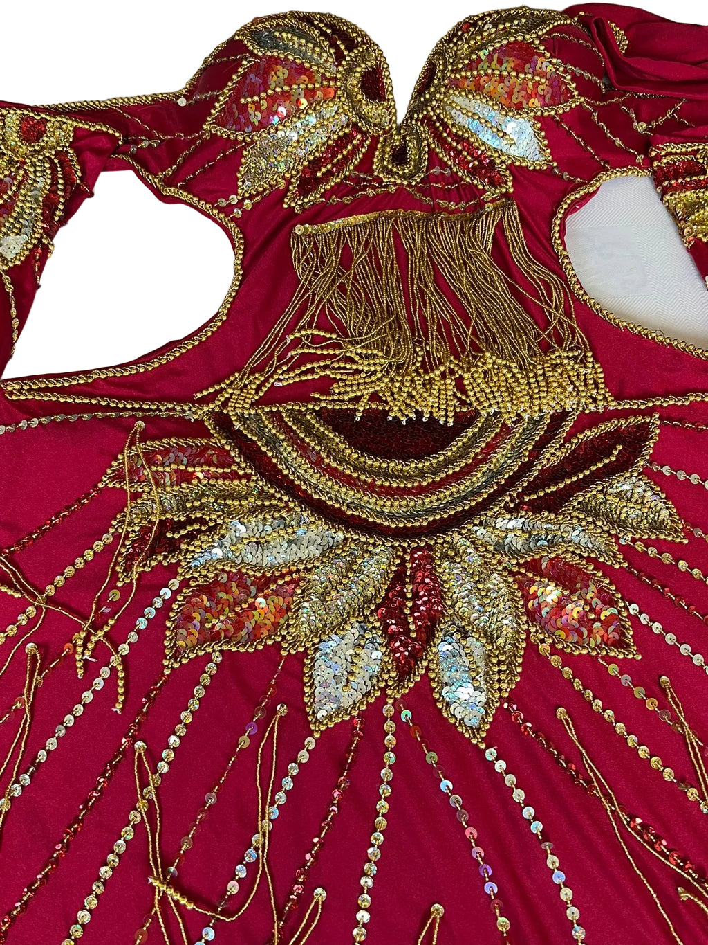 Red fabric with gold and silver embroidery on a white background