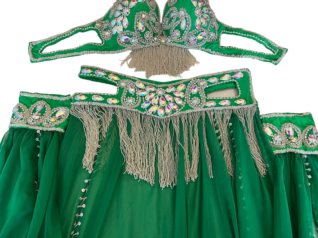 Green embroidered garment with fringes on a table