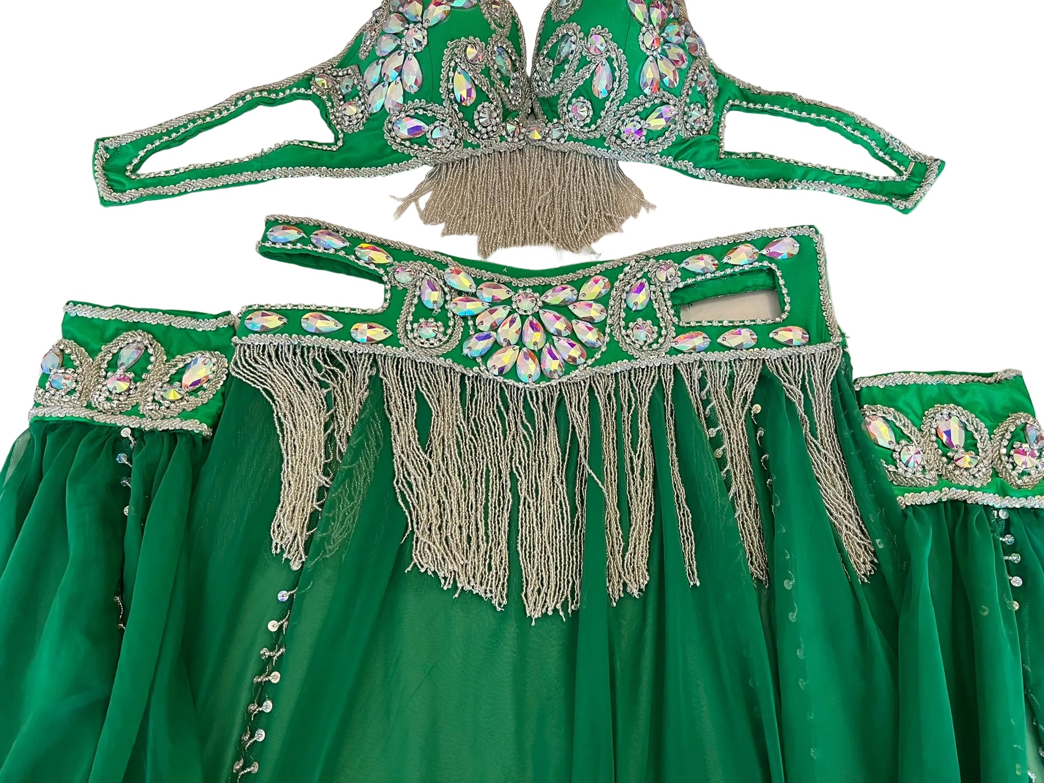 Green embroidered garment with fringes on a table