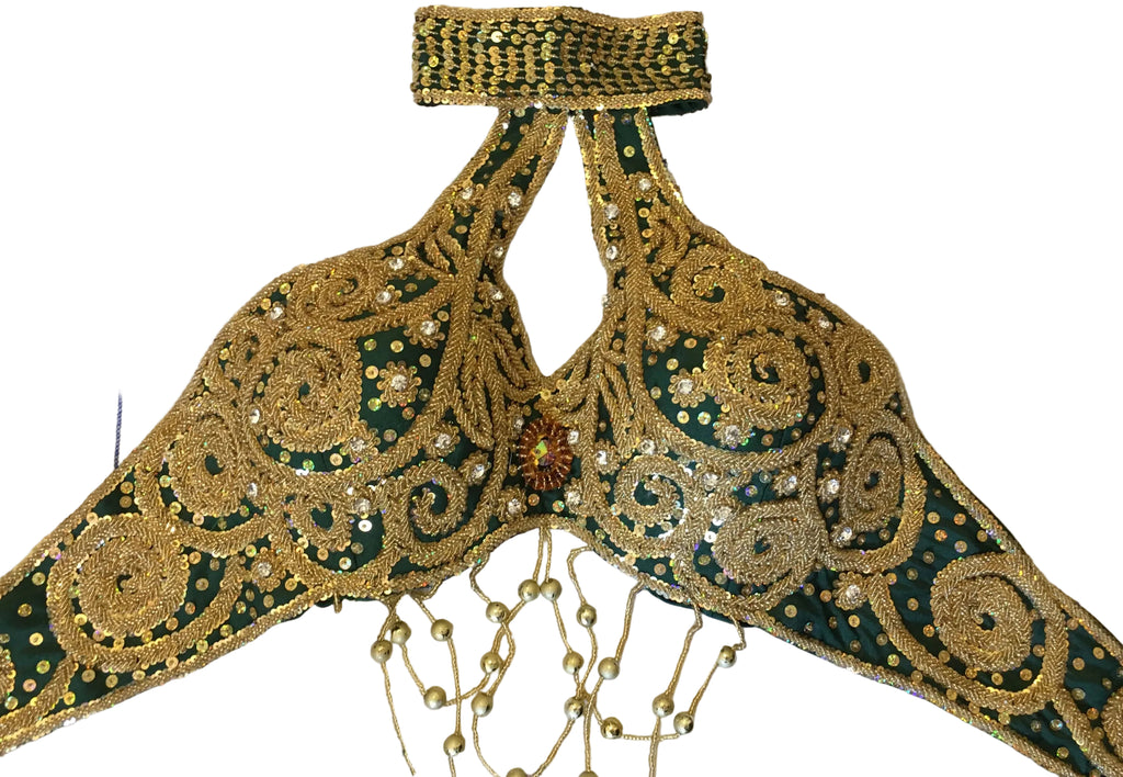 Decorative piece with gold and green embroidery on a floral-patterned fabric background