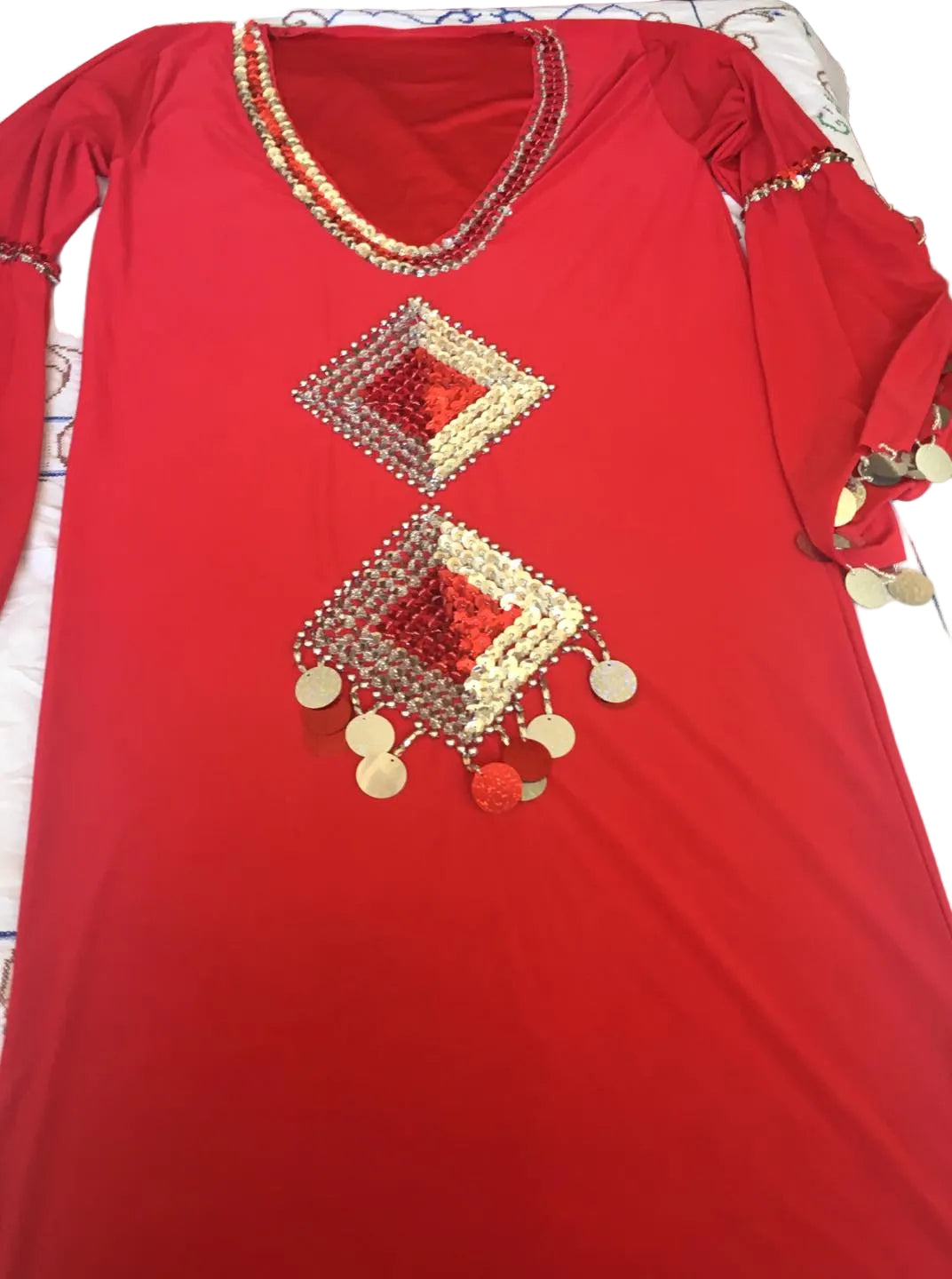 A red Egyptian belly dance dress with geometric patterned embroidery and decorative elements.