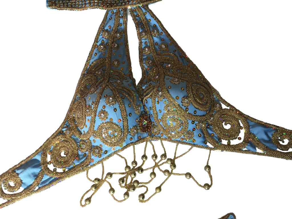 Decorative blue and gold lace trim on a textured fabric background