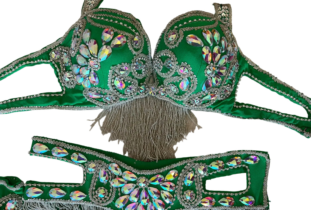 Green embellished bra and belt set on a neutral background