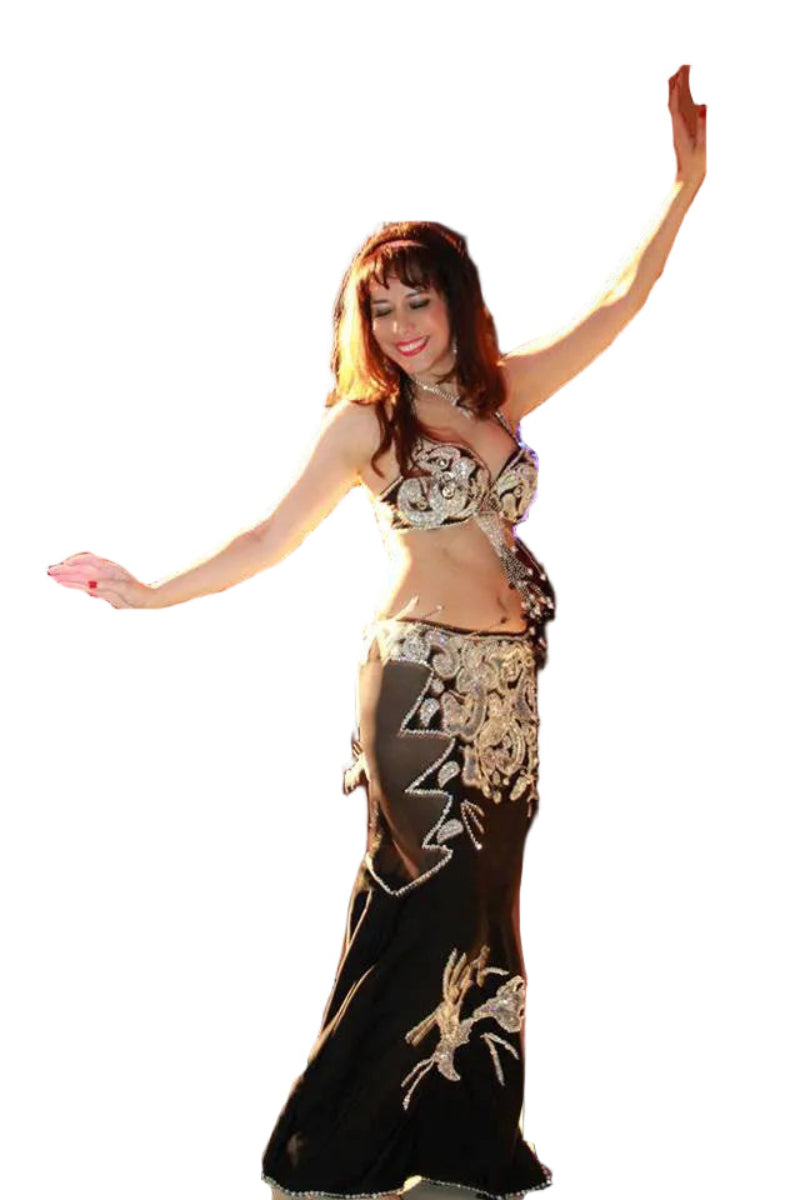 Woman in a belly dance costume with floral patterns on a white background