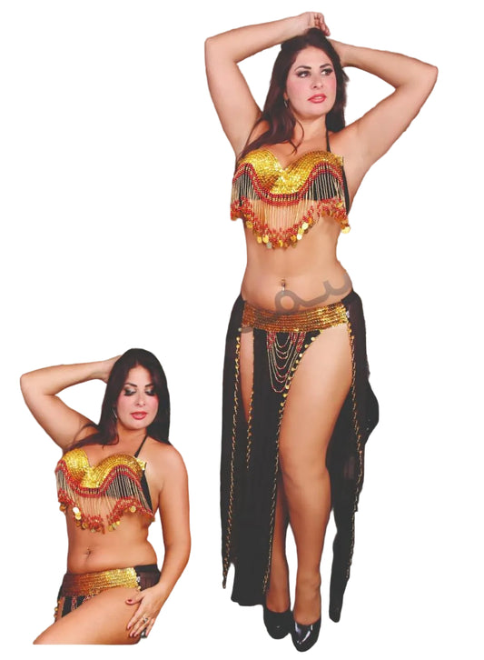 Model wearing a belly dance costume with intricate designs, posing against a tiled wall.