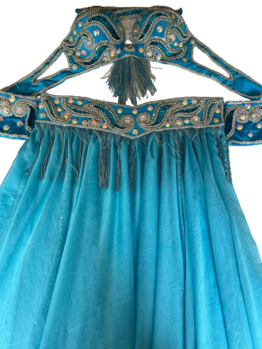 A professional Egyptian belly dance costume with a blue chiffon skirt, attached bra belt with gold-colored embellishments, and a pair of arm pieces with decorative sleeve patterns.