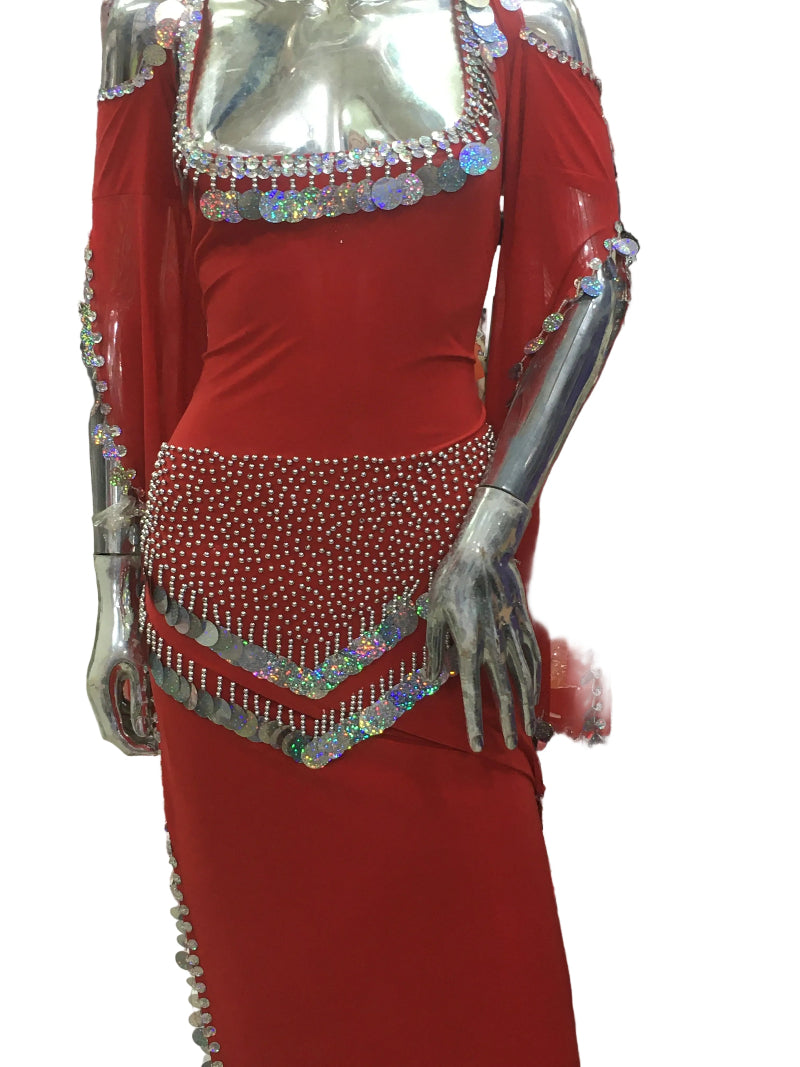 Red belly dance outfit with silver embellishments on a mannequin in a store setting