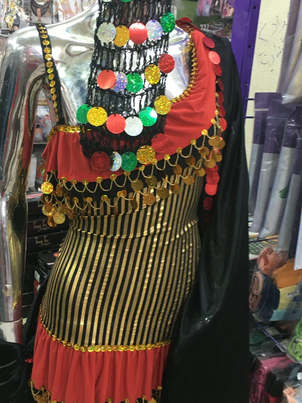 Decorative headpiece with colorful beads and a striped pattern on a reflective surface.