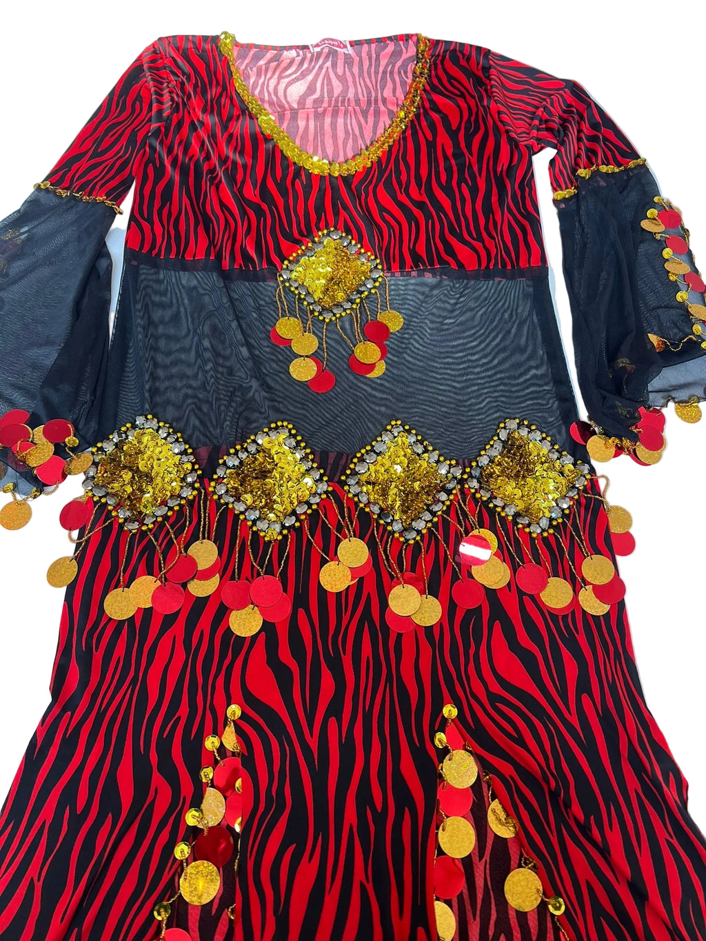 Colorful dress with red and black zebra pattern, gold embellishments, and red polka dots on a white background.