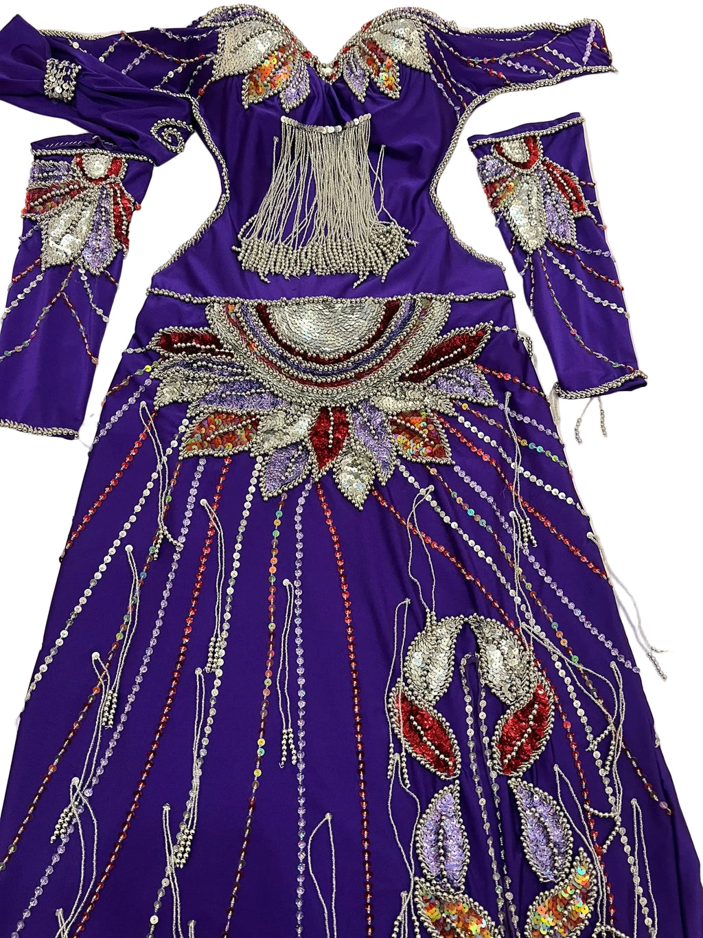Decorative purple garment with intricate beadwork on a flat surface