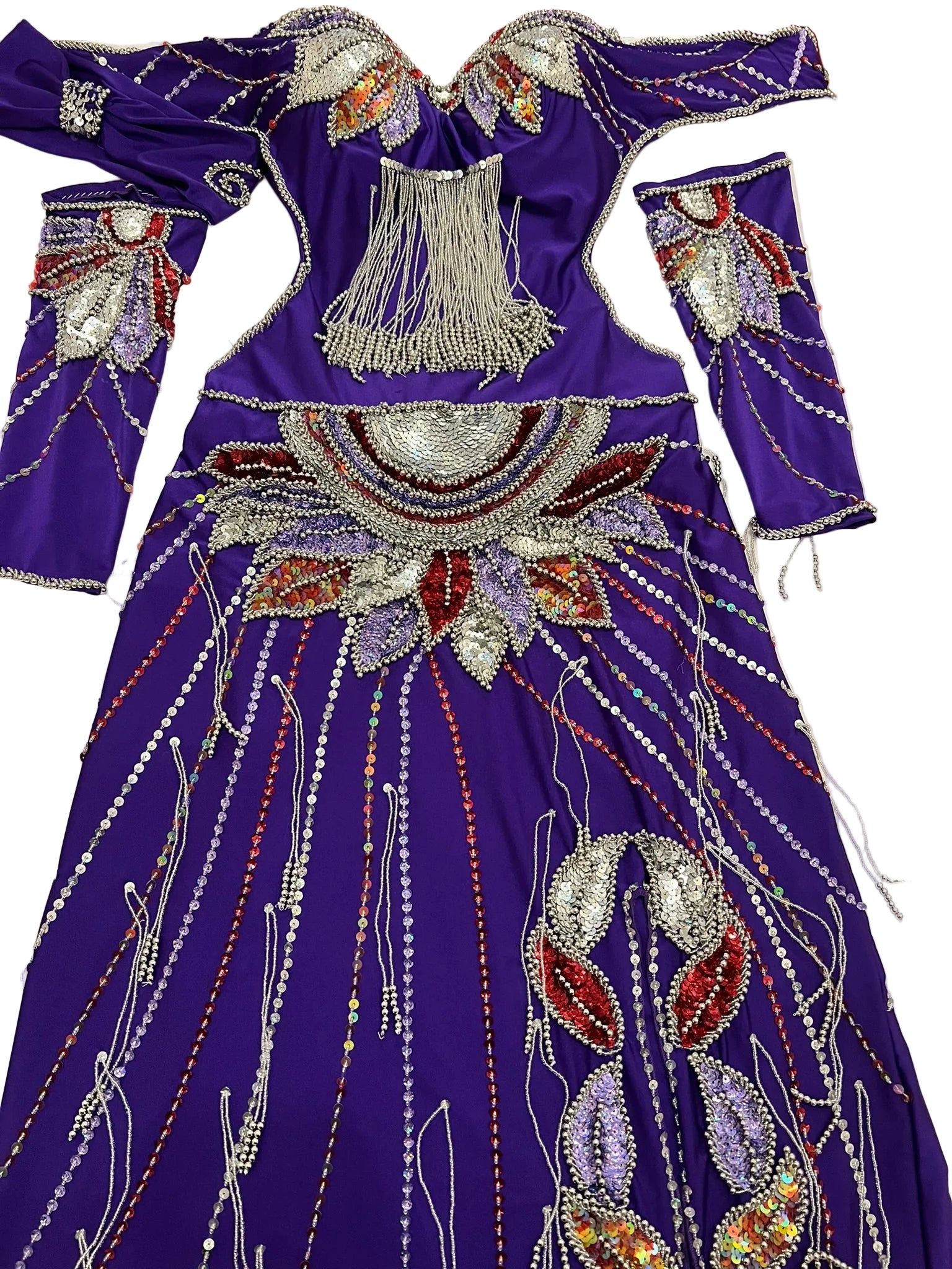 Decorative purple garment with intricate beadwork on a flat surface