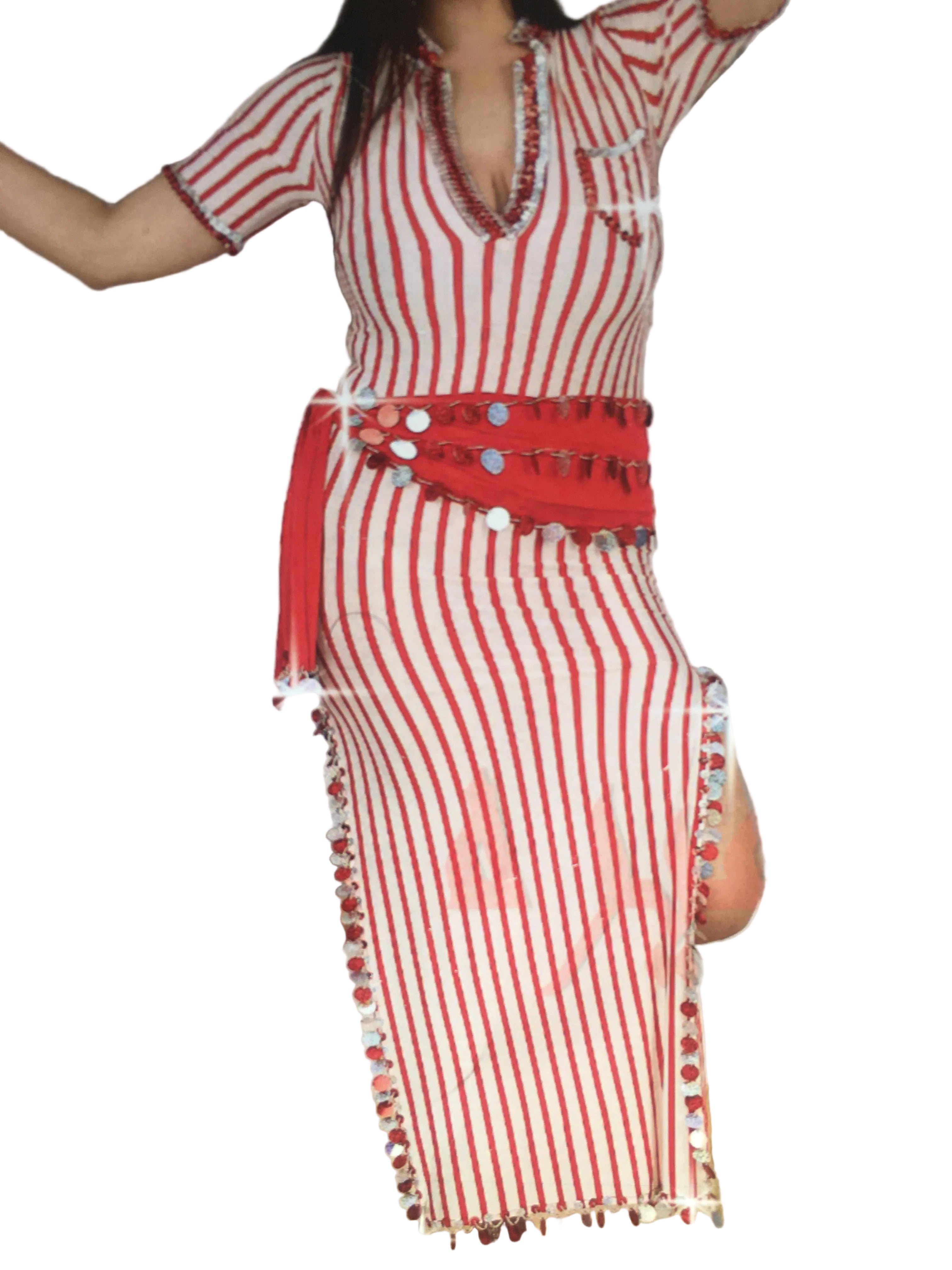 Person wearing a red and white striped outfit with pom-pom details, standing in front of a mirror.