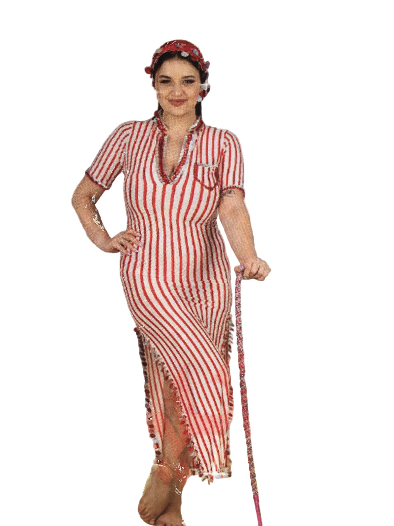 Woman in a red and white striped dress standing in front of a mirror.