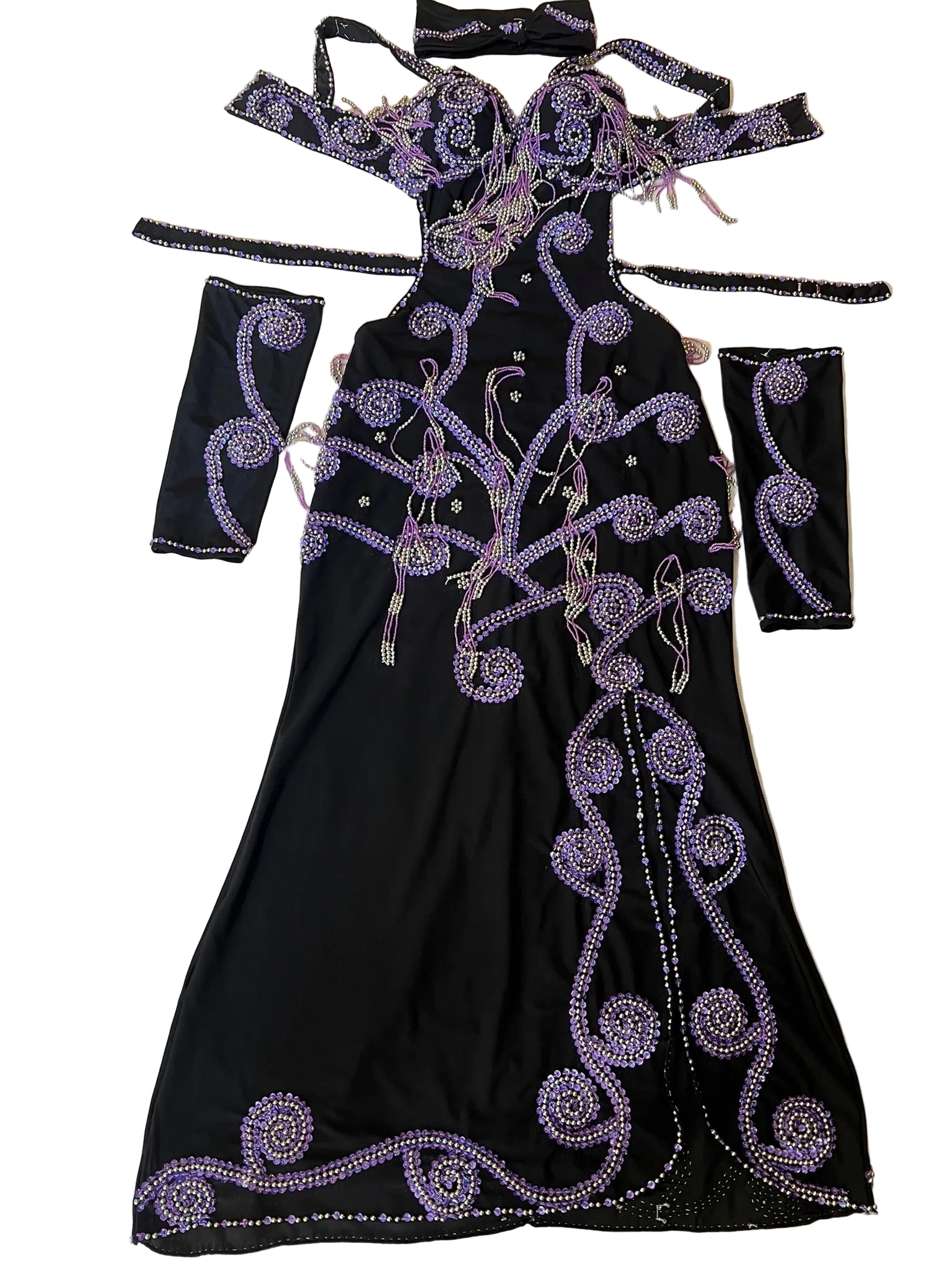 A custom-made black belly dance costume with purple embellishments, including a one-piece dress, arm pieces, and a headpiece.