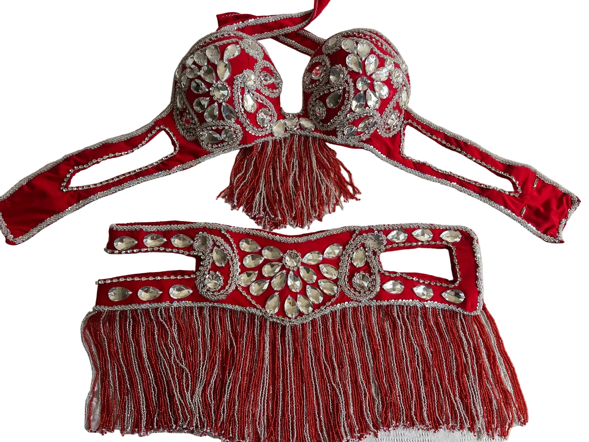 A professional Egyptian belly dance costume set featuring a red bra with embellishments and a matching red belt with fringes, adorned with glass stones, beads, and rhinestones.