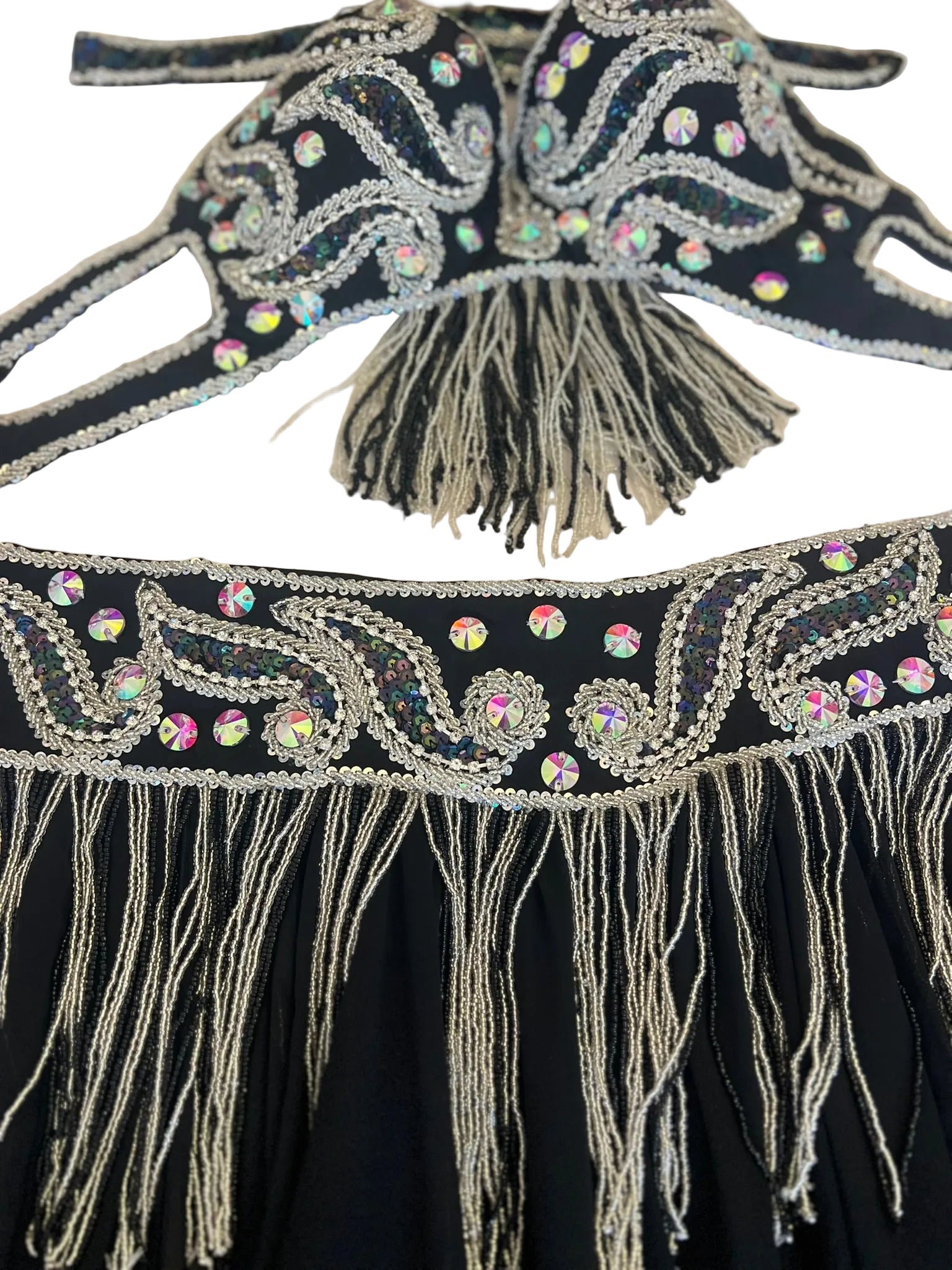 Decorative black fabric with silver embroidery and tassels on a white background