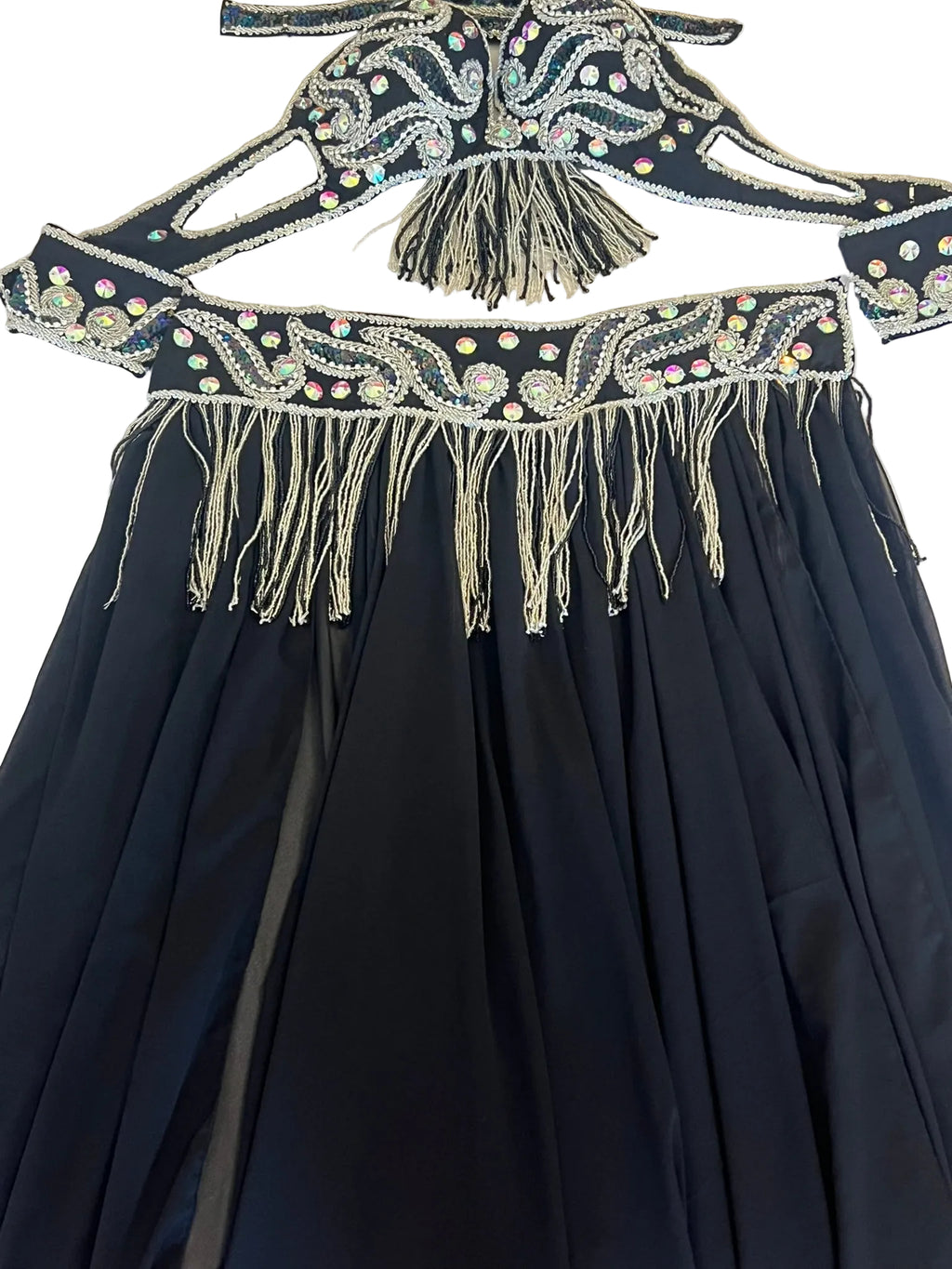 Black dress with intricate beaded and fringed top on a white background