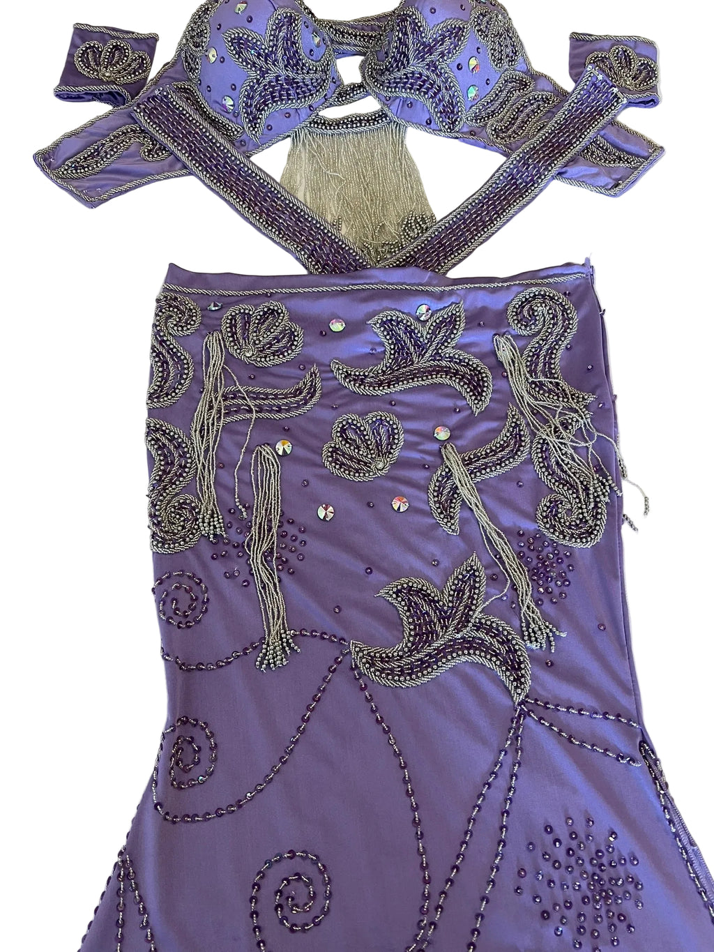 Purple embellished belly dance costume on a white surface