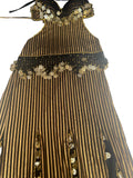 A traditional Egyptian belly dance costume featuring black and white stripes with elaborate handmade embroidery and sequins.