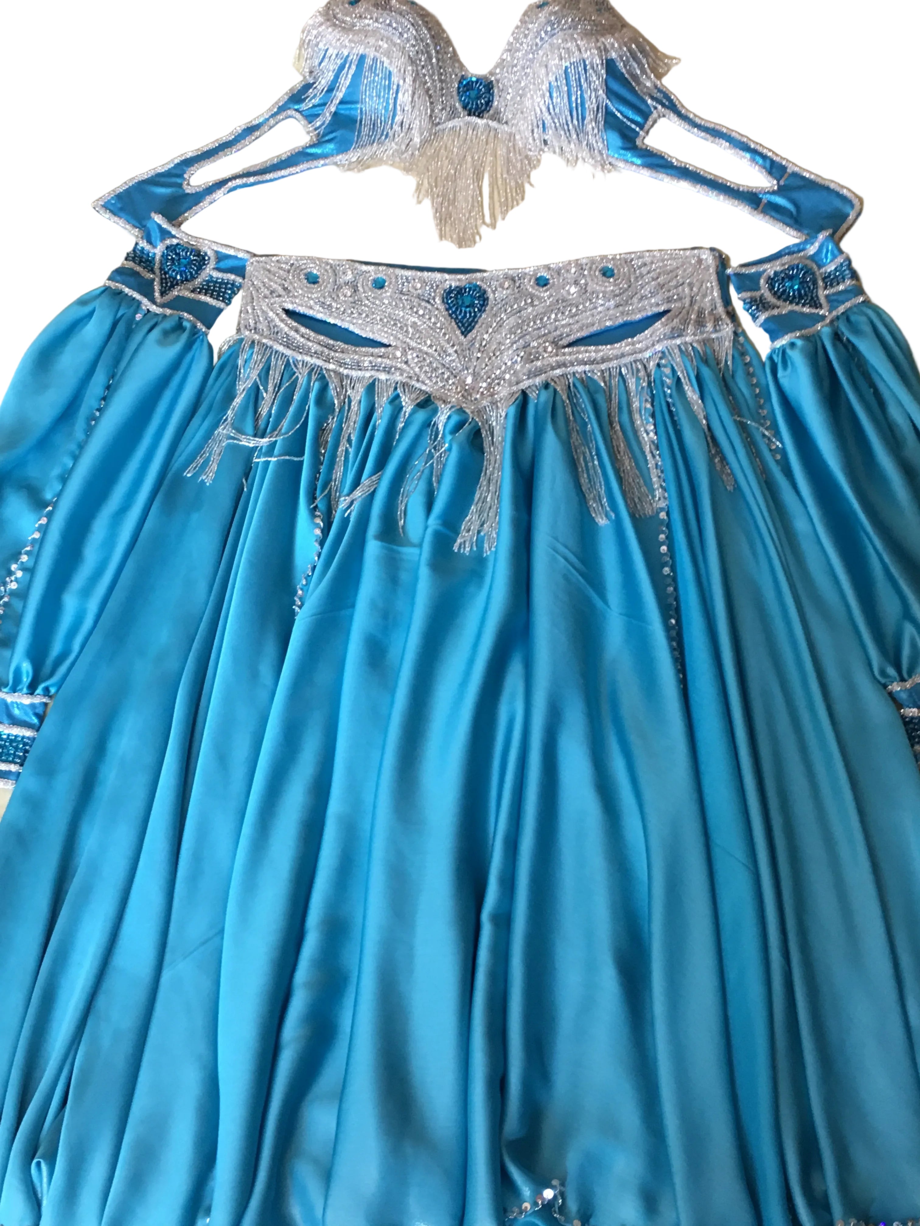 Blue fabric with silver embroidery on a beige background