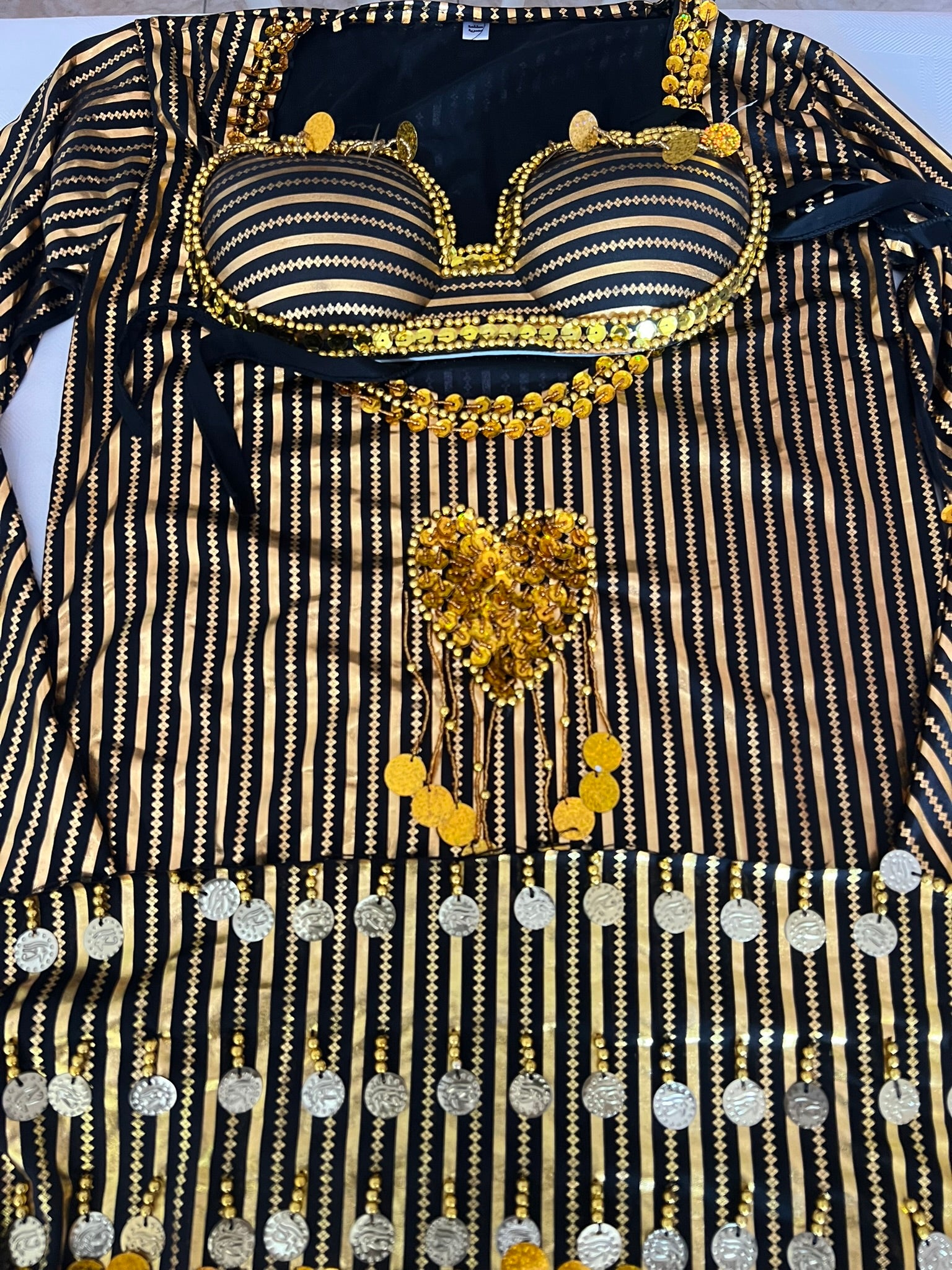 Decorative black and gold garment with intricate patterns and embellishments.