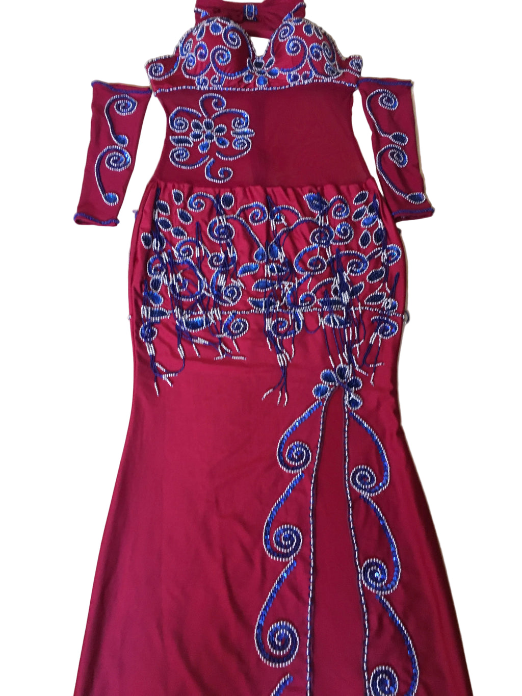 A professional belly dance costume consisting of a red one-piece dress with blue embroidery, a tulle fabric connecting the skirt and bra, and includes a pair of sleeves and a headband.