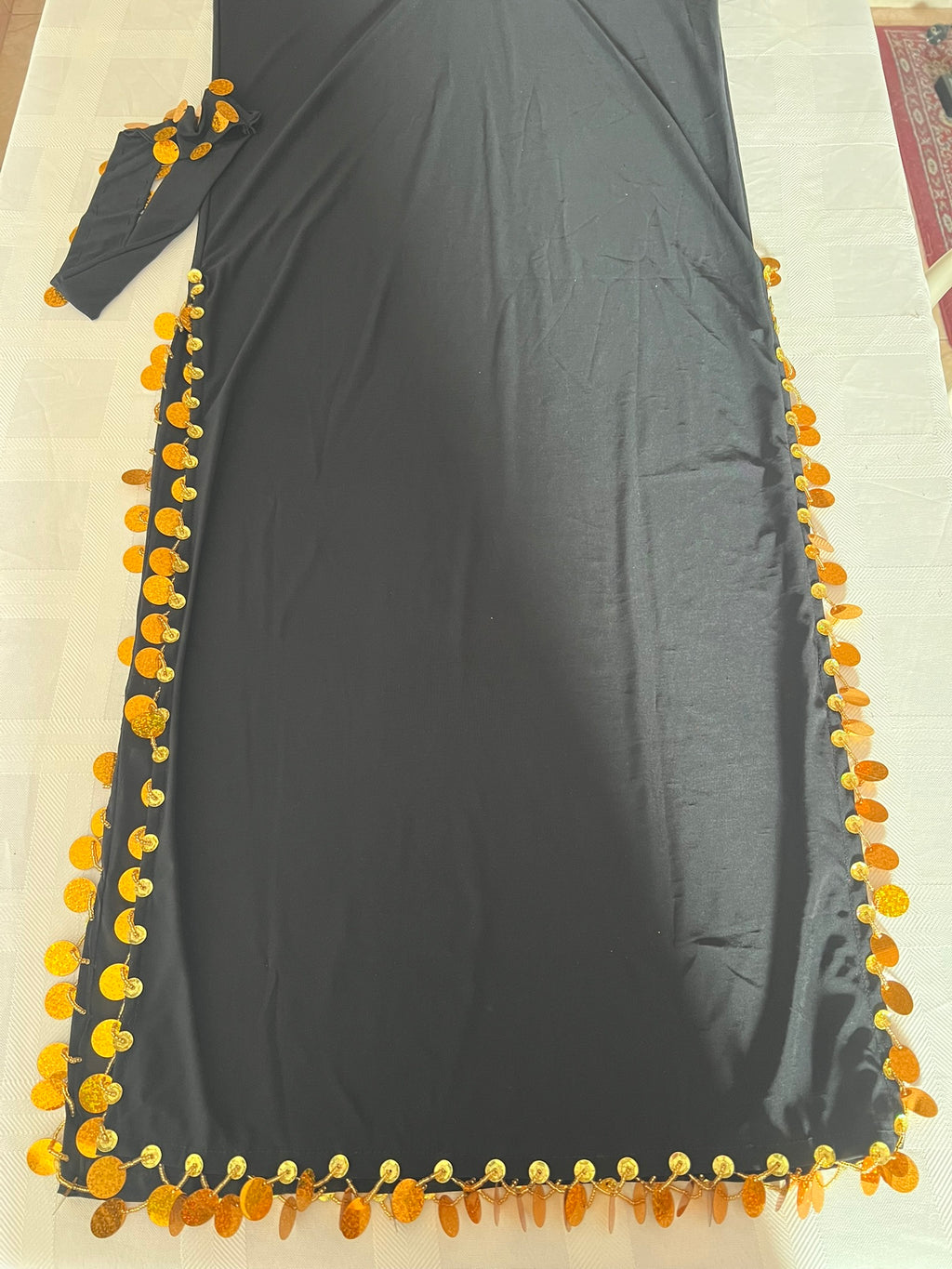 Dark gray dress with yellow floral embellishments on a light background