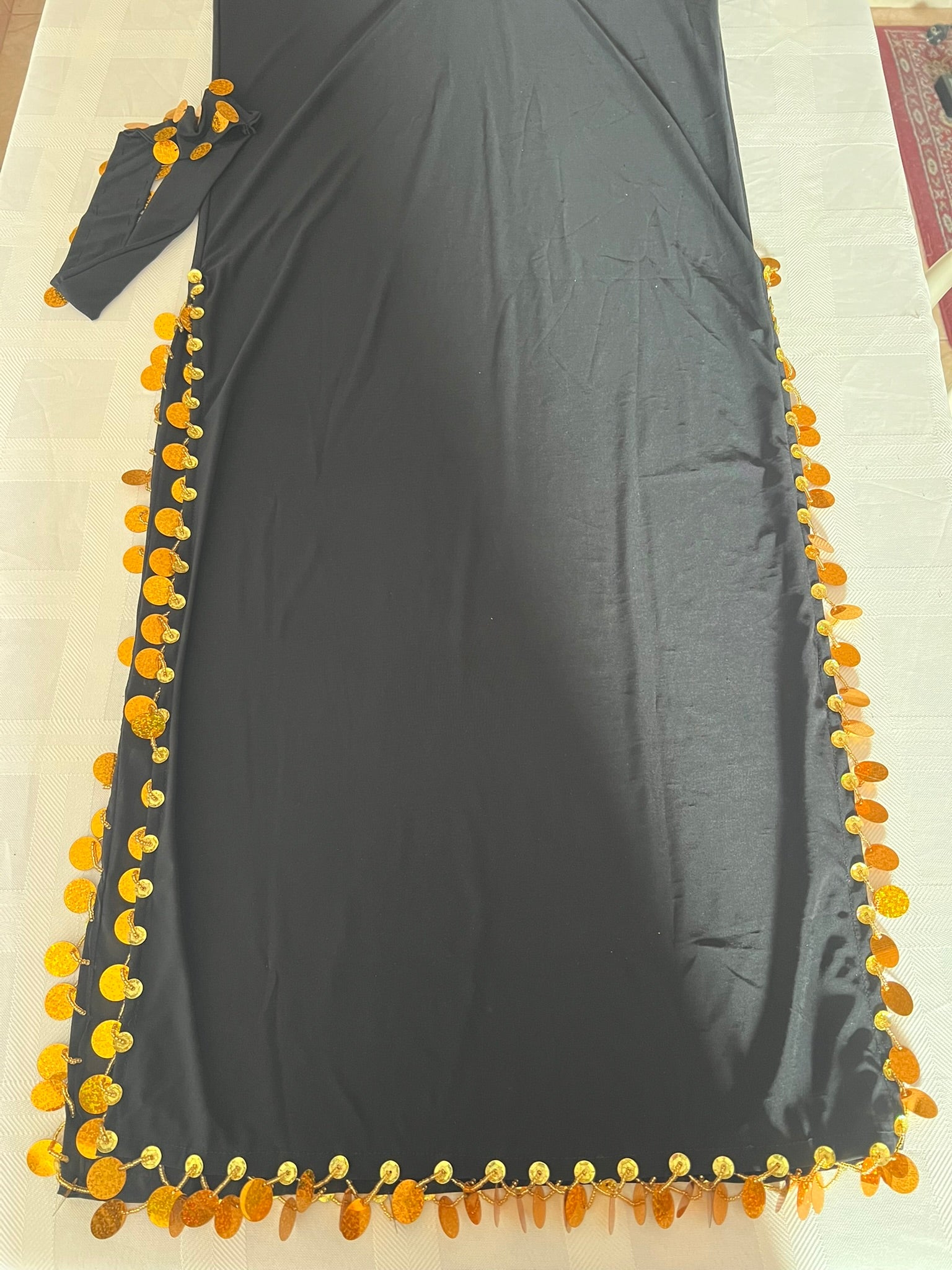 Dark gray dress with yellow floral embellishments on a light background