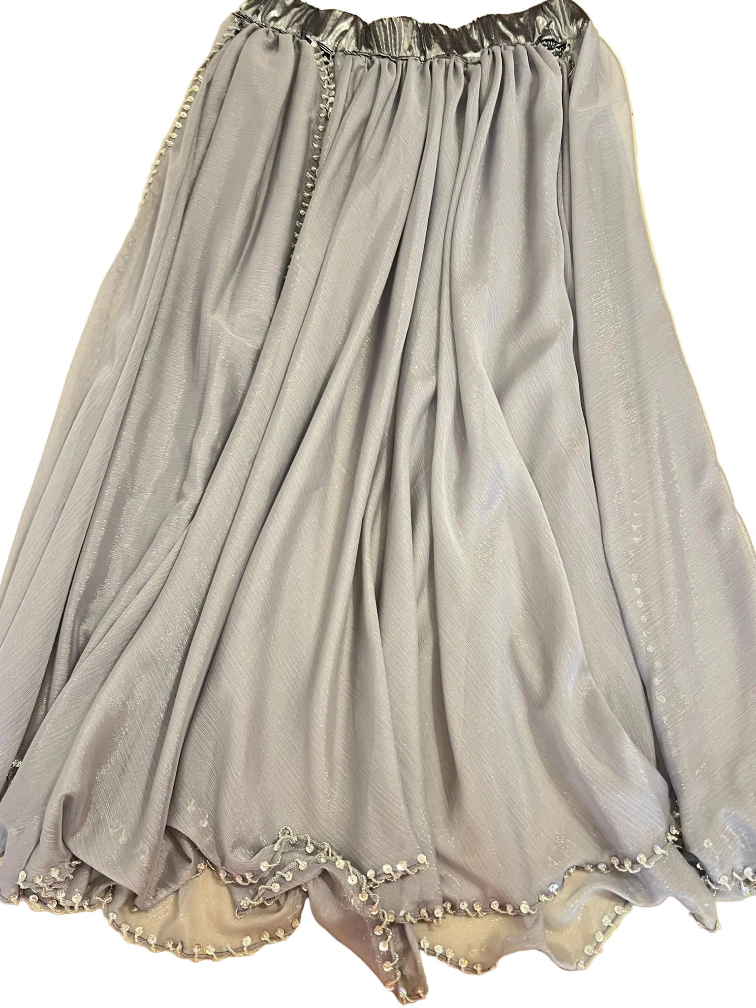 Gray dress with decorative trim on a yellow surface