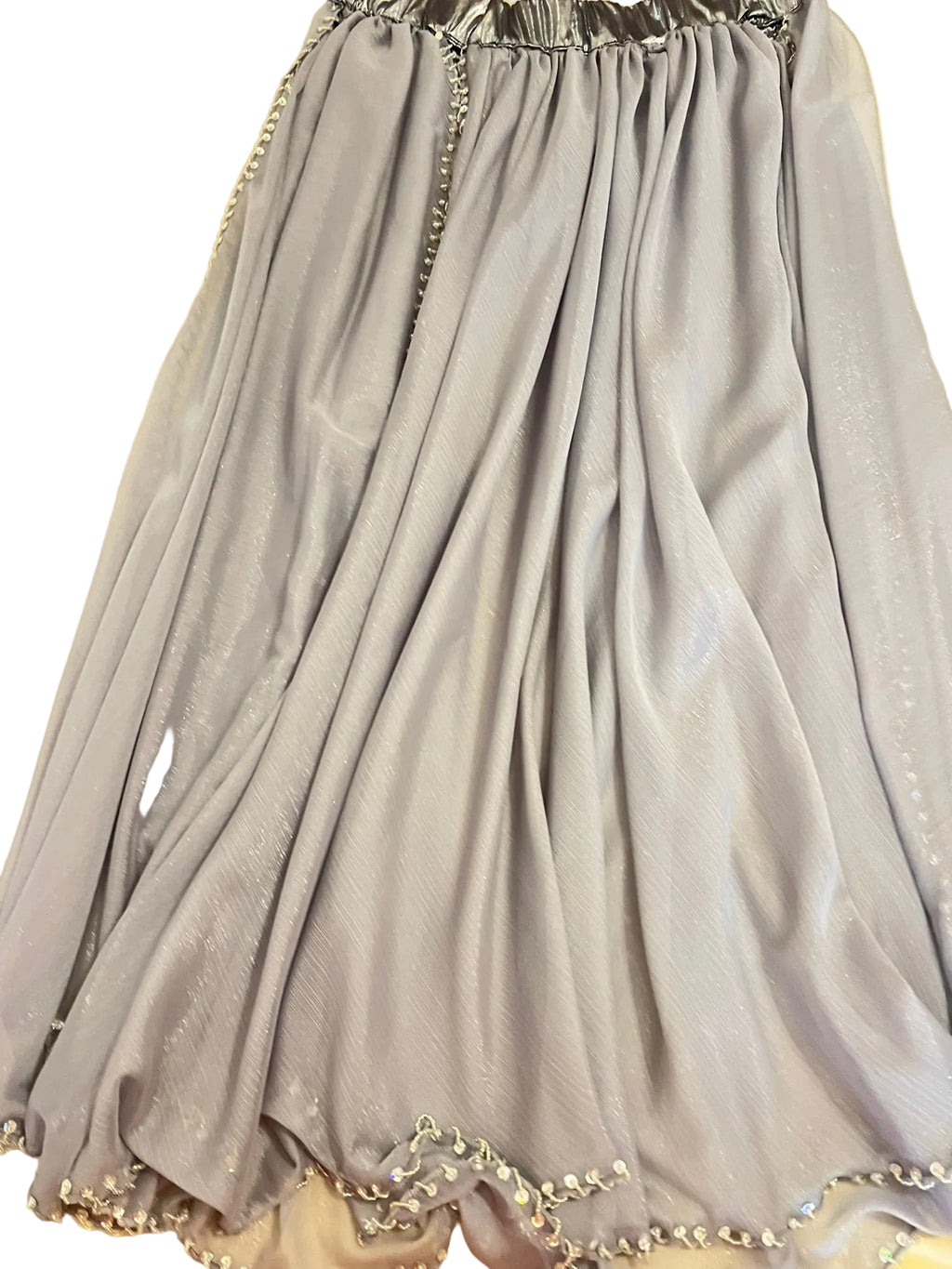 Gray dress with decorative trim on a yellow surface