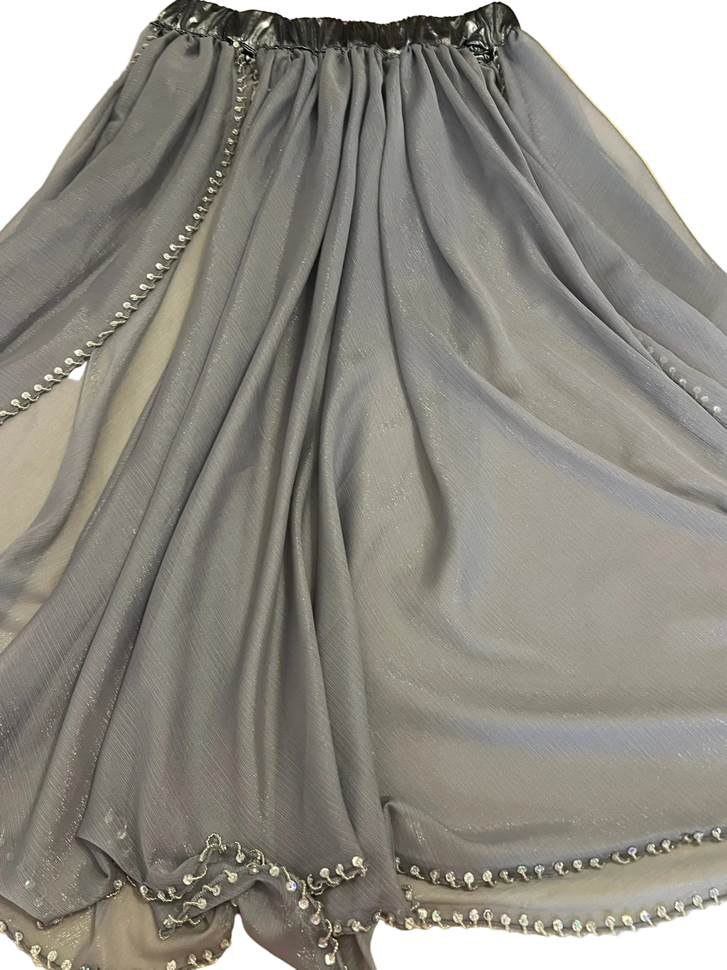 Gray skirt with decorative trim on a flat surface