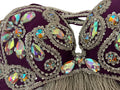 Decorative Belly dance bra with rhinestones on a purple background