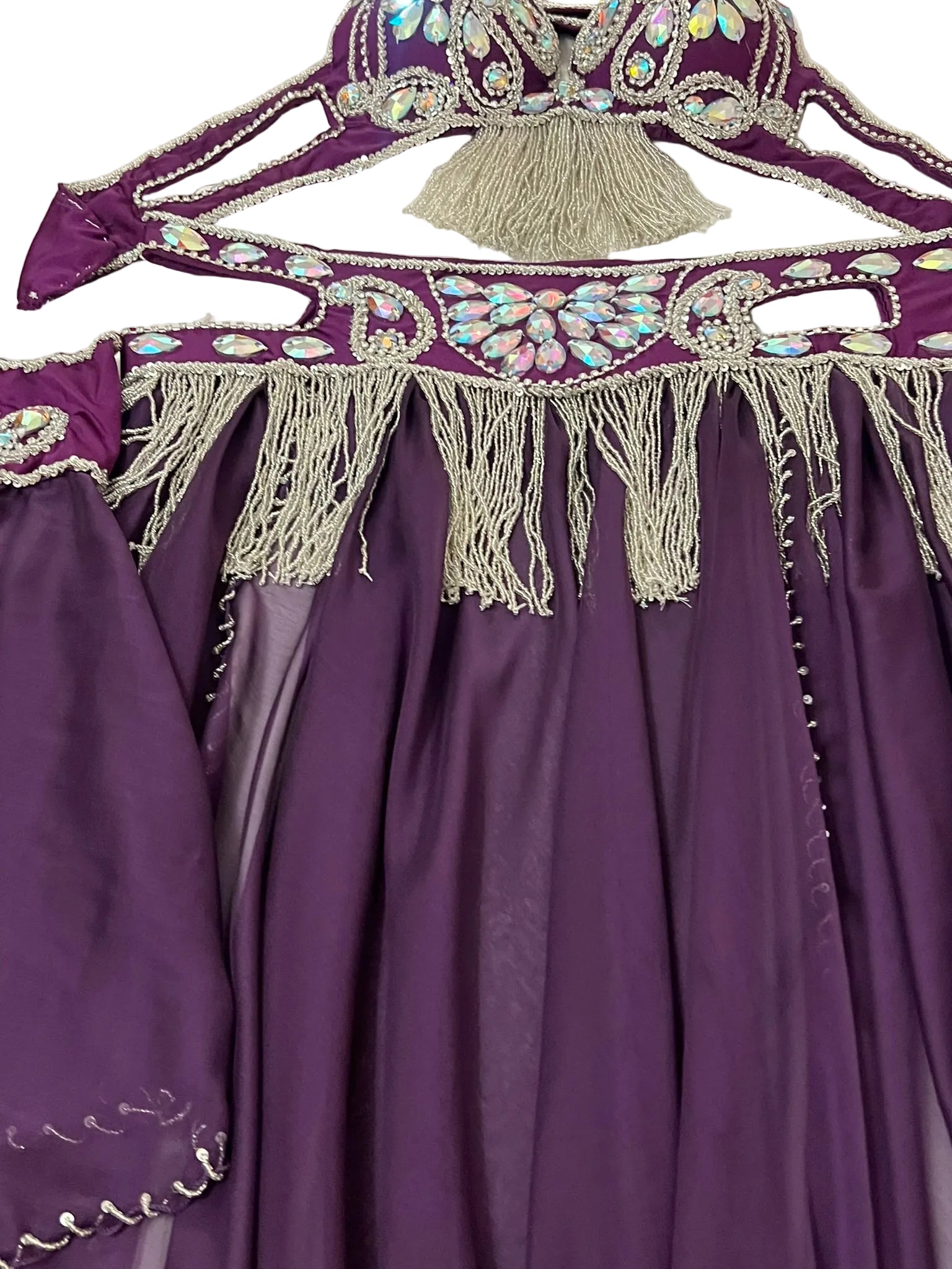 Purple embroidered garment with intricate designs on a white background